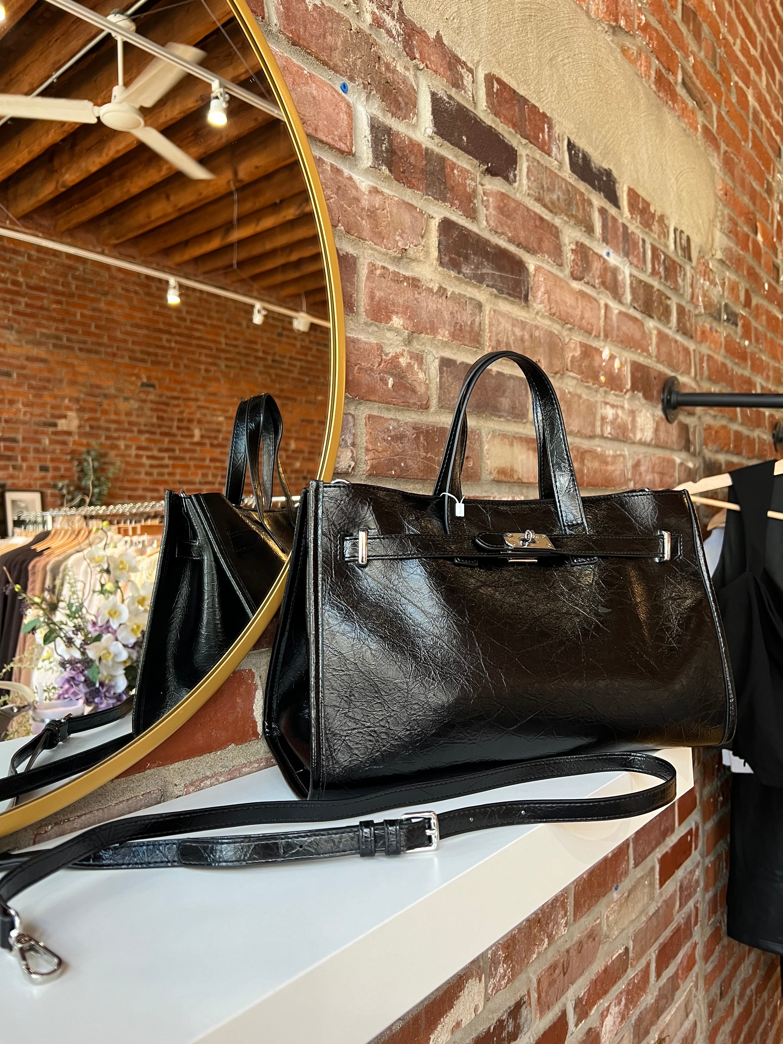Jetta Black Leather Tote Bag with structured shape, top handles, and matching removable inner pouch