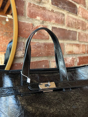 Jetta Black Leather Tote Bag with structured shape, top handles, and matching removable inner pouch