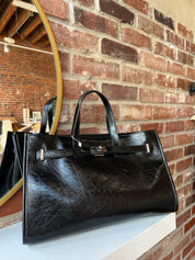 Jetta Black Leather Tote Bag with structured shape, top handles, and matching removable inner pouch