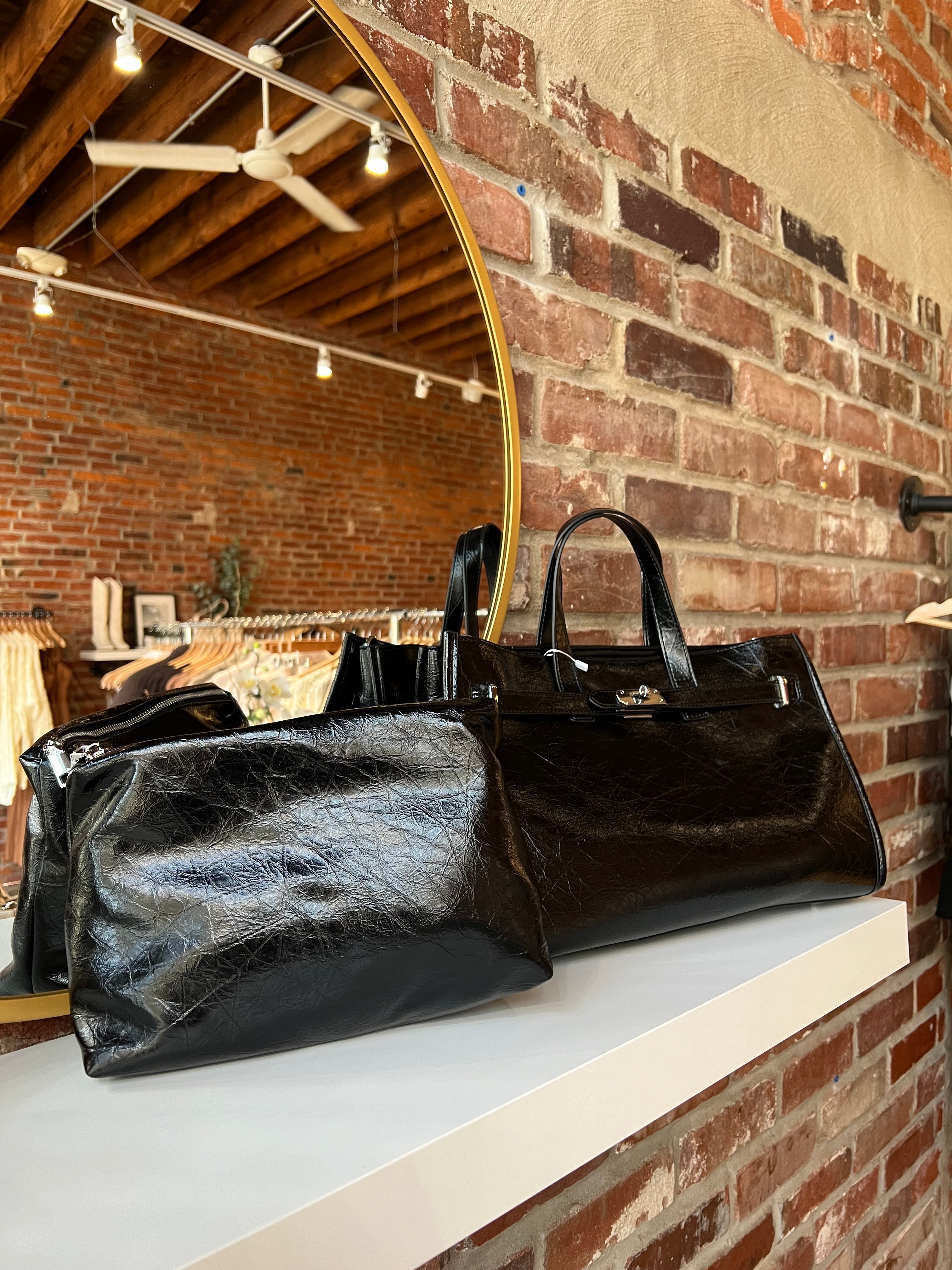 Jetta Black Leather Tote Bag with structured shape, top handles, and matching removable inner pouch