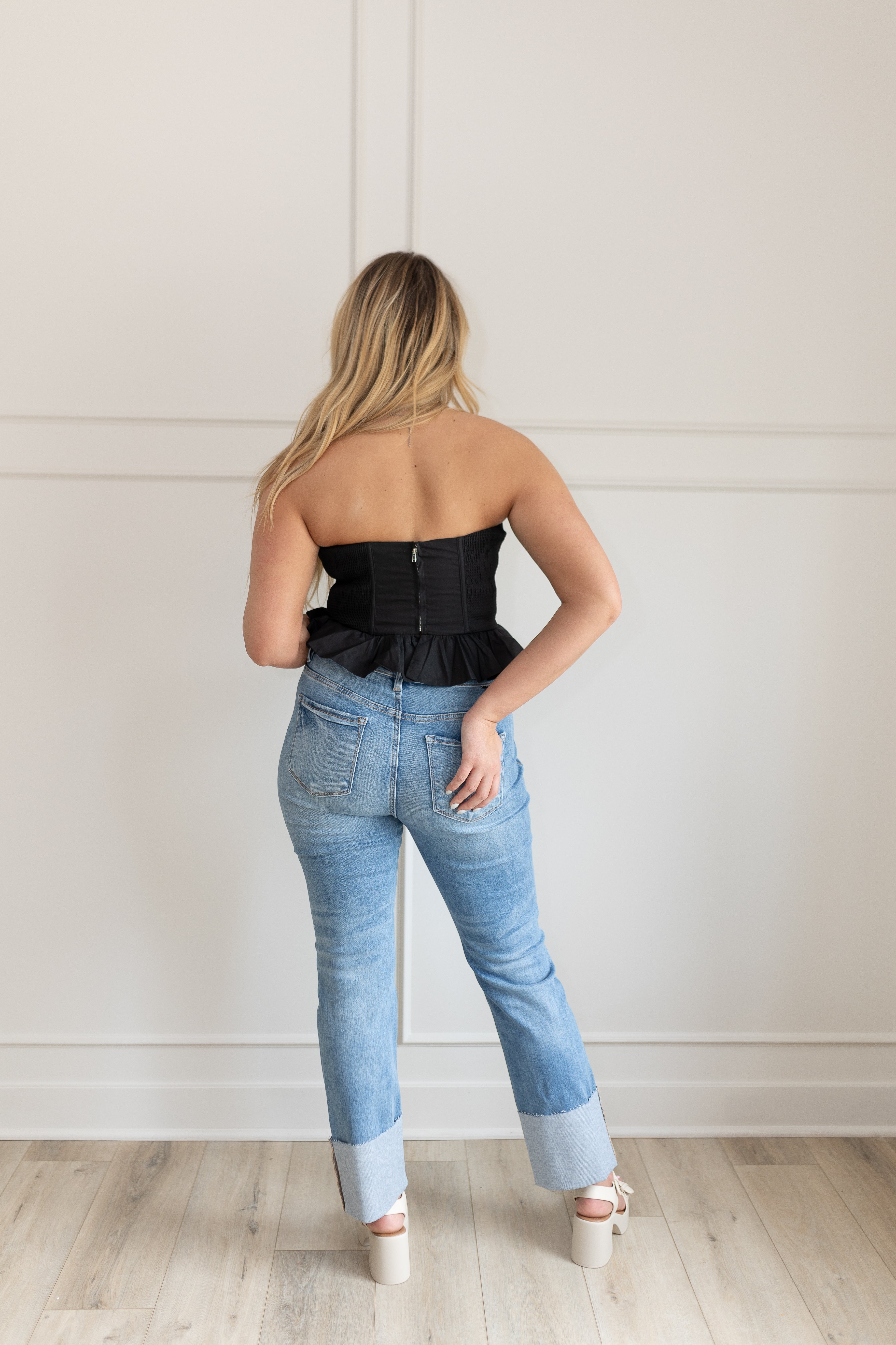 Black strapless corset top with peplum hem and fitted bodice