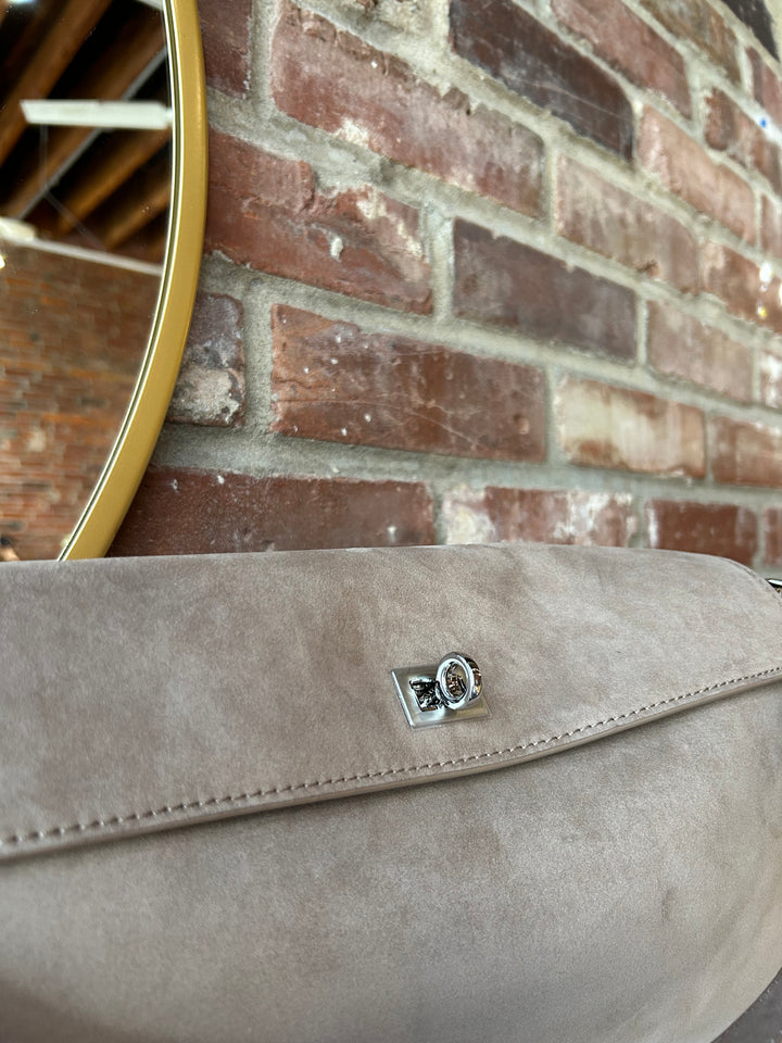 Beige suede shoulder bag with metal hardware and removable shoulder strap.