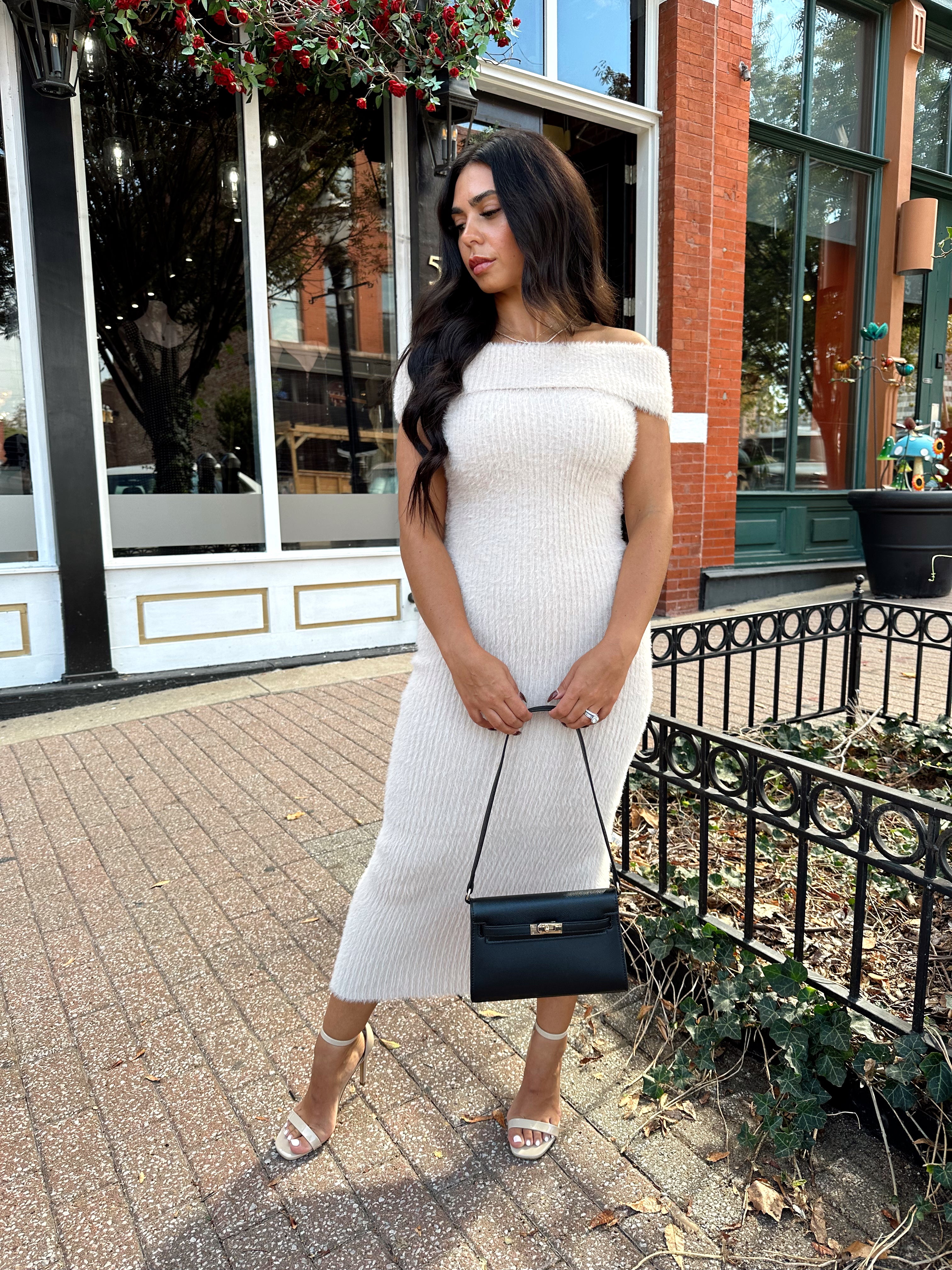 Women wearing cream colored furry off the shoulder midi dress.