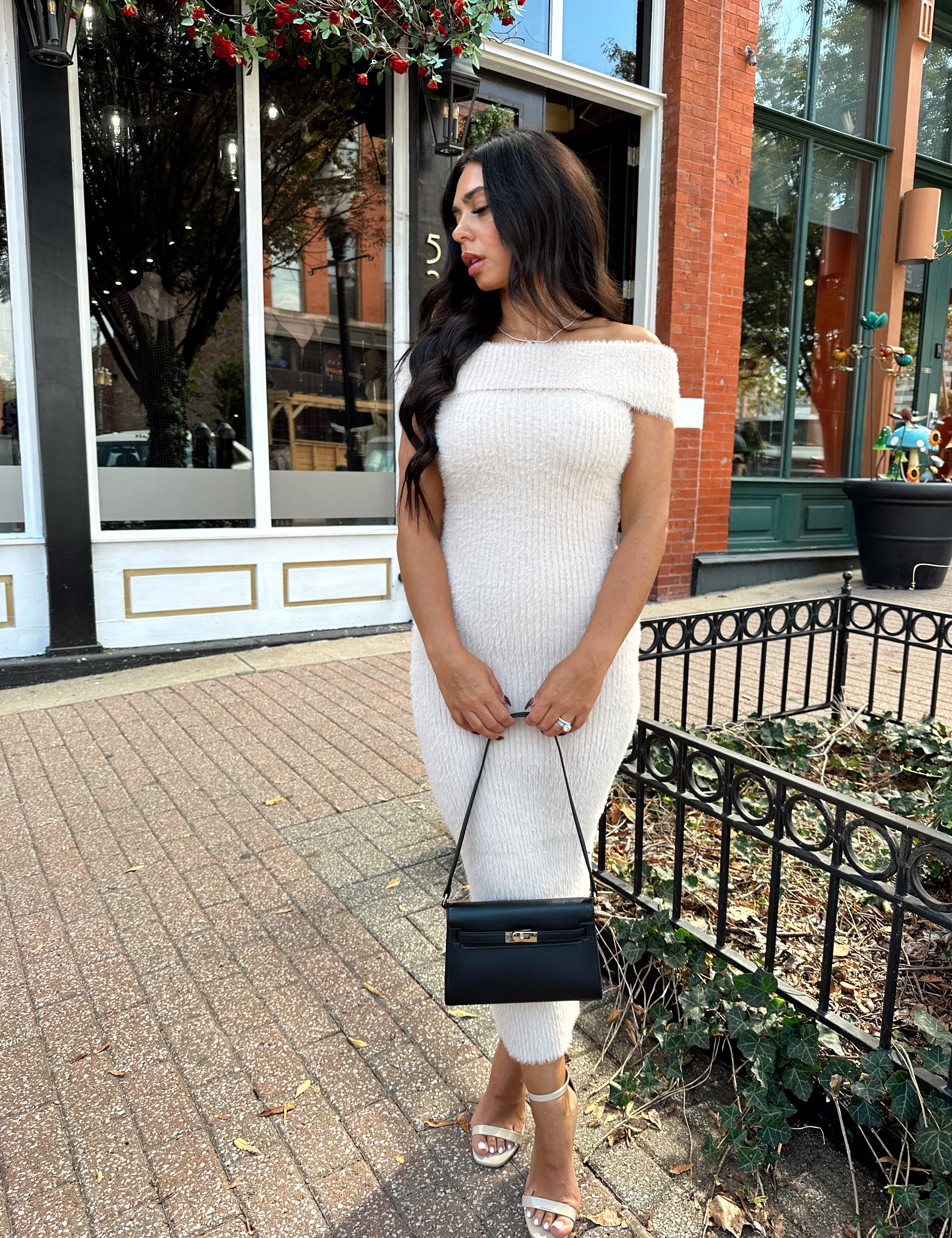 Women wearing cream colored furry off the shoulder midi dress.