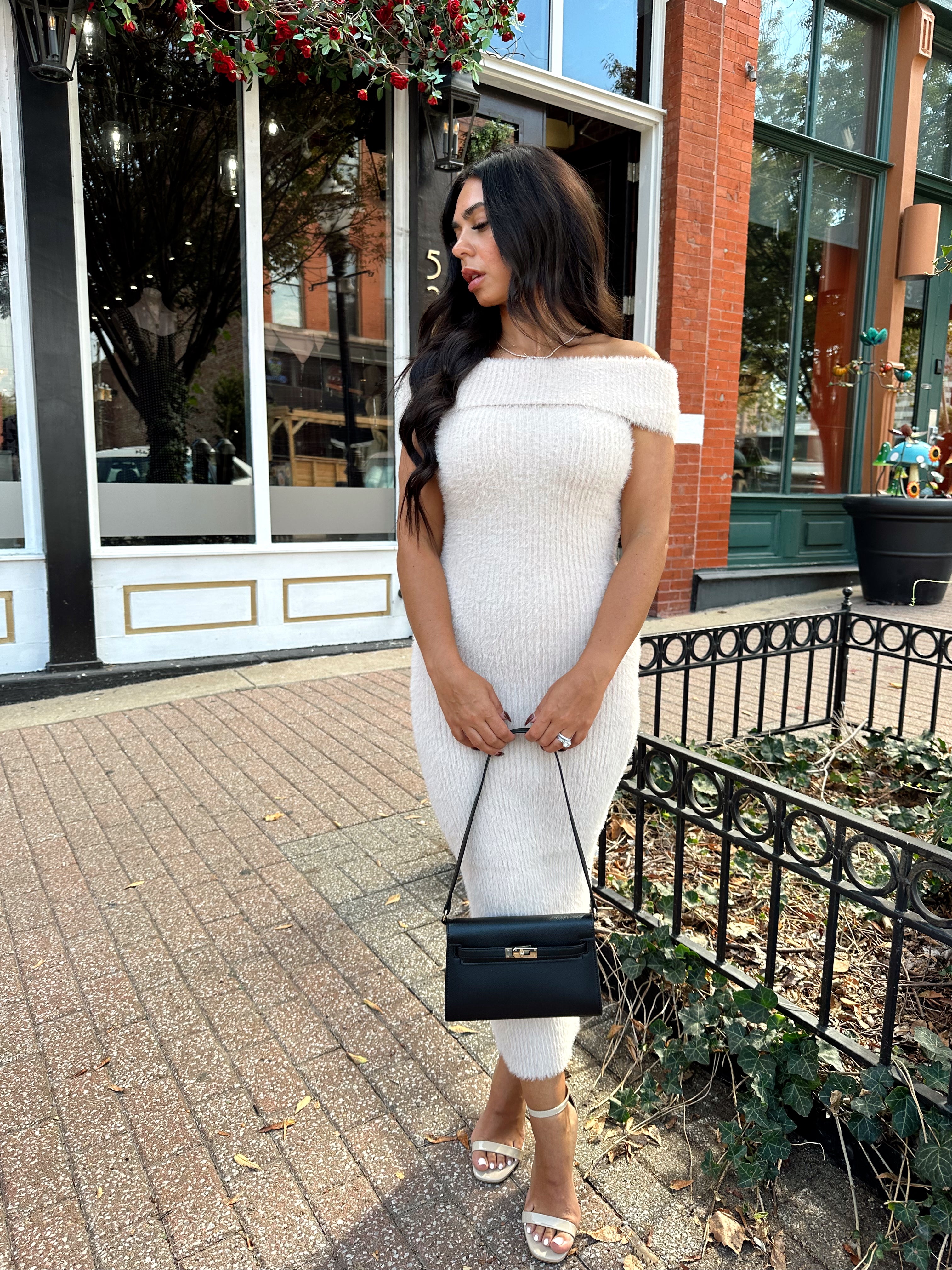 Women wearing cream colored furry off the shoulder midi dress.