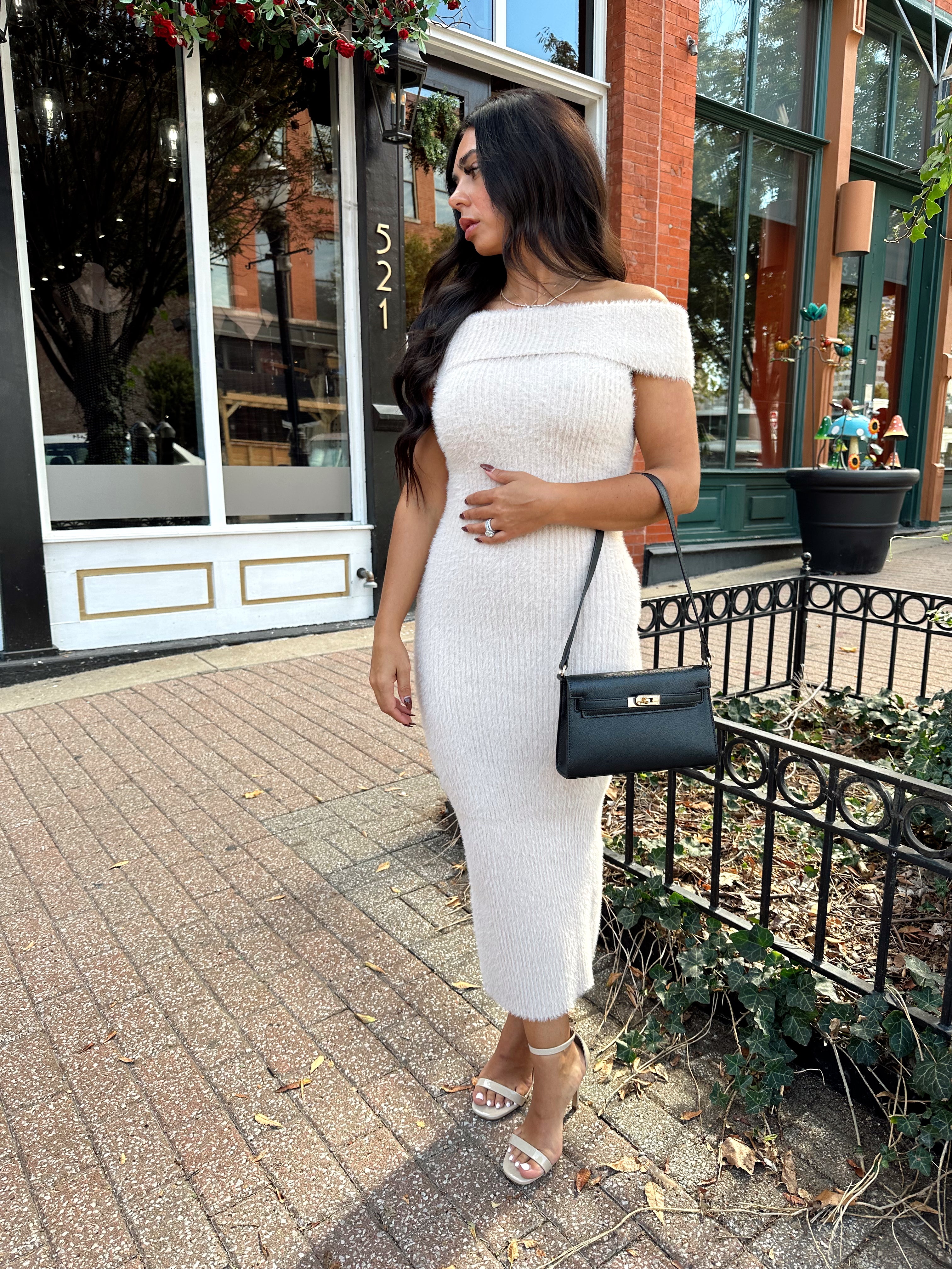 Women wearing cream colored furry off the shoulder midi dress.