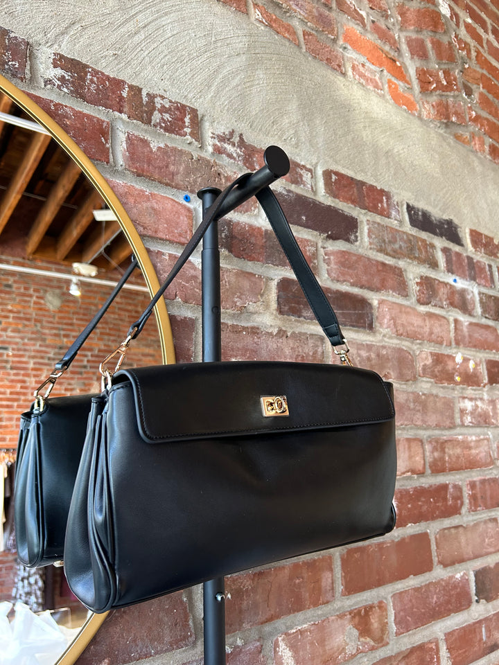 Black leather shoulder bag with metal hardware and removable shoulder strap.