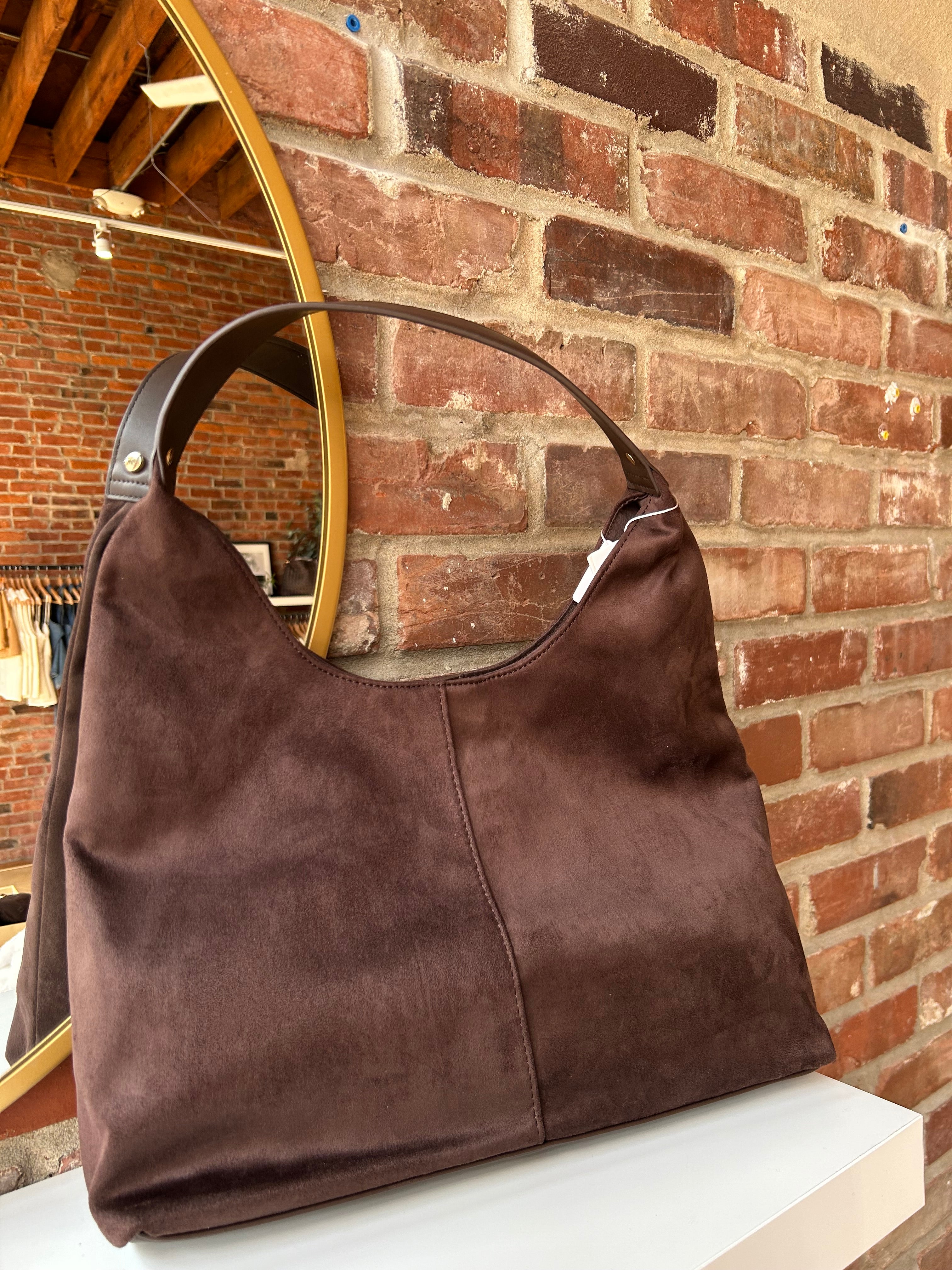 Brown suede shoulder bag with structured handle and roomy minimalist silhouette