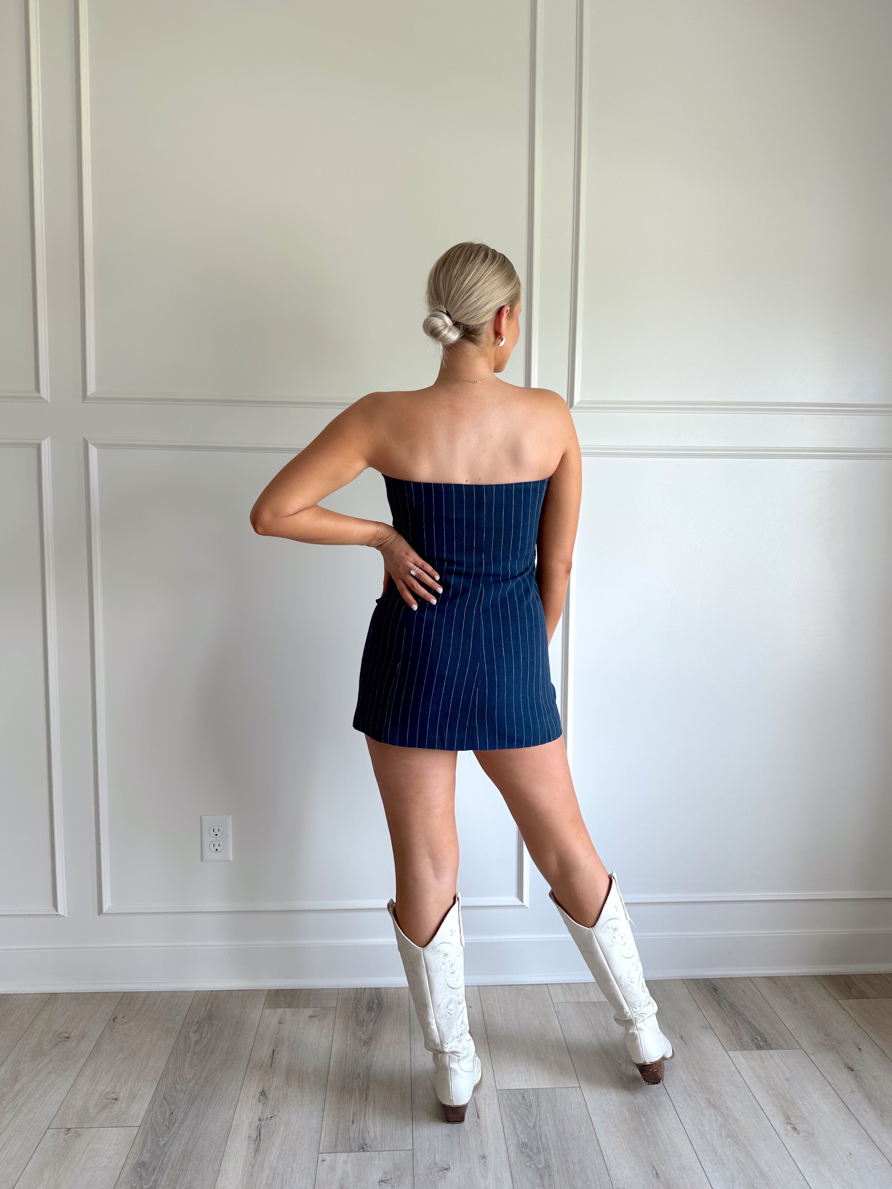 Navy blue pinstripe sleeveless mini dress with button closure. 