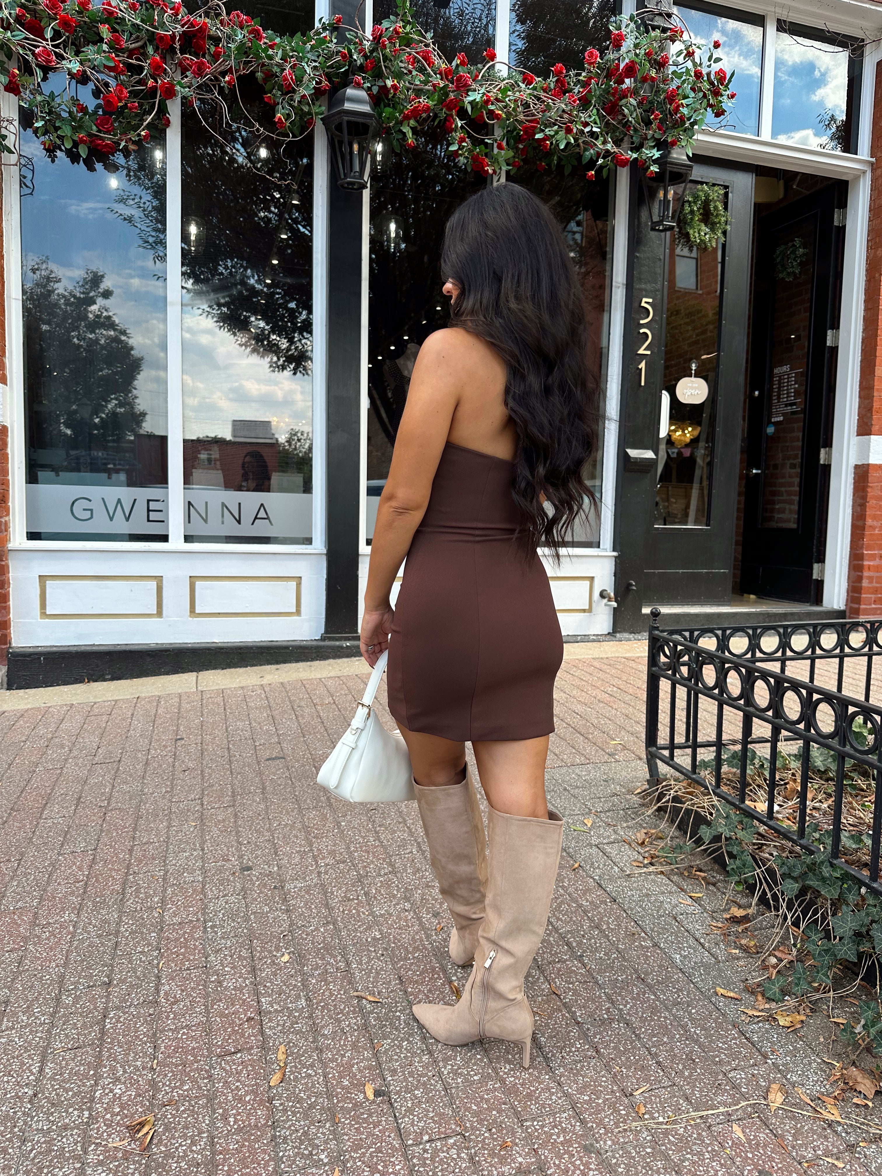 Woman wearing brown mini dress with front zipper closure, and collar neckline detail. 