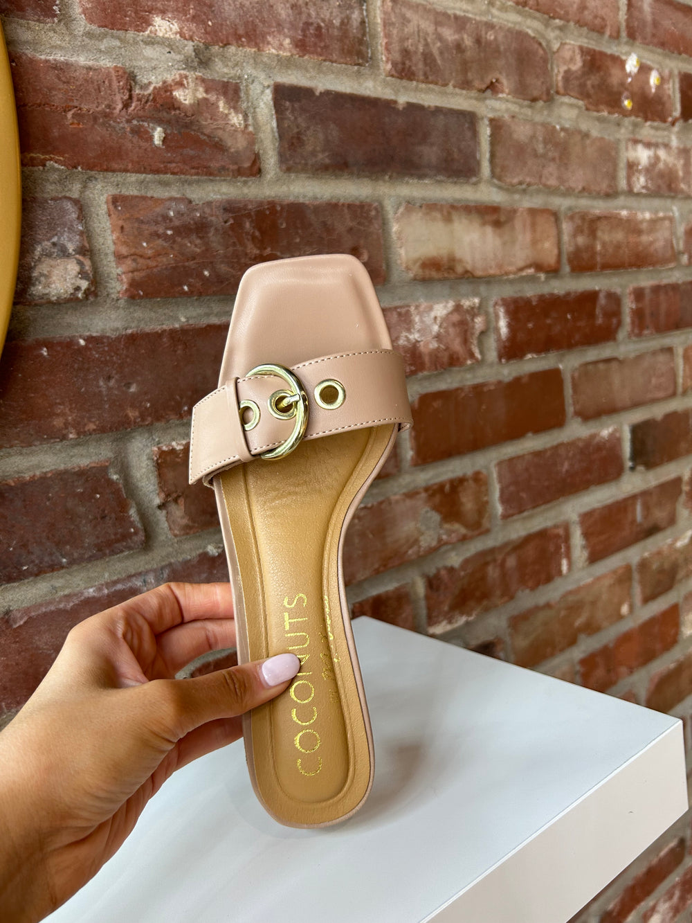 Open toed tan kitten heel with buckle detail.