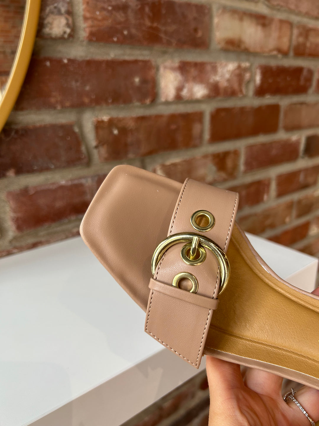 Open toed tan kitten heel with buckle detail.