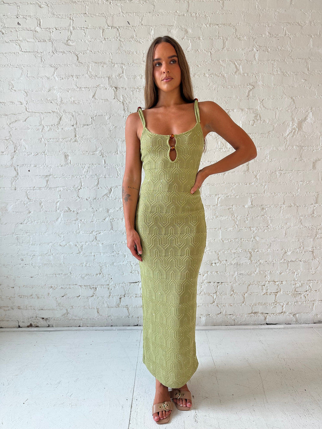 Woman wearing olive green shimmer knit midi dress.