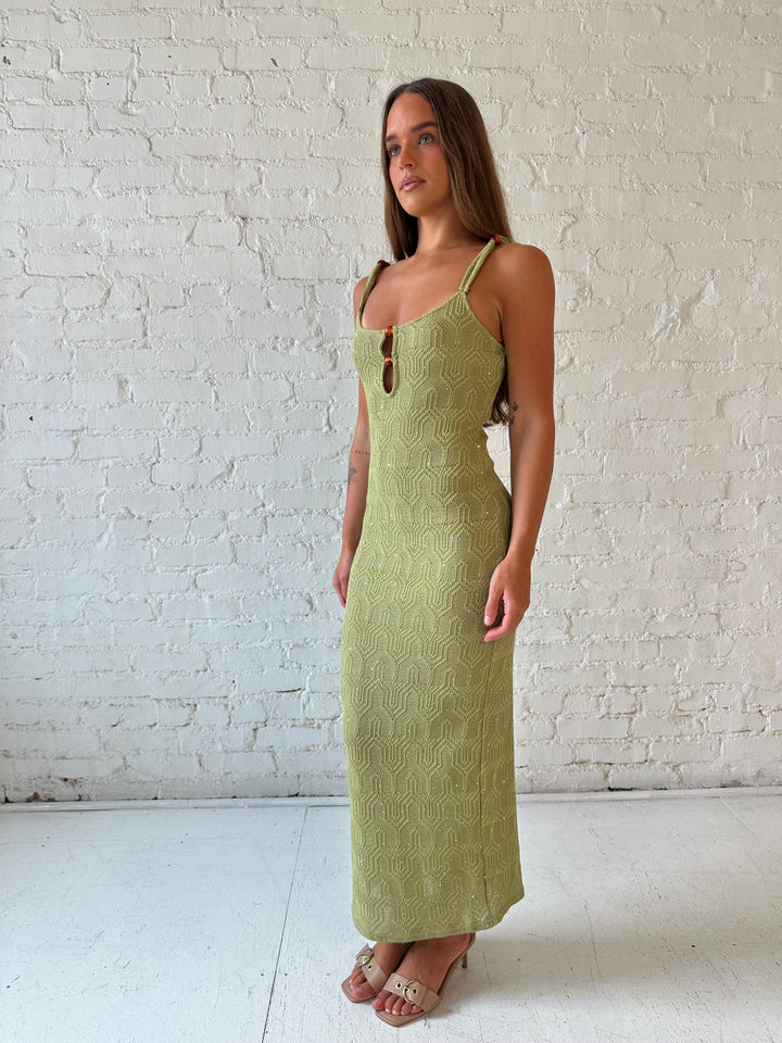 Woman wearing olive green shimmer knit midi dress.