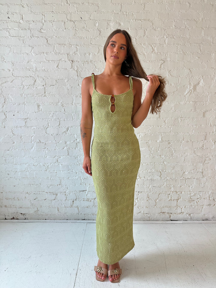 Woman wearing olive green shimmer knit midi dress.