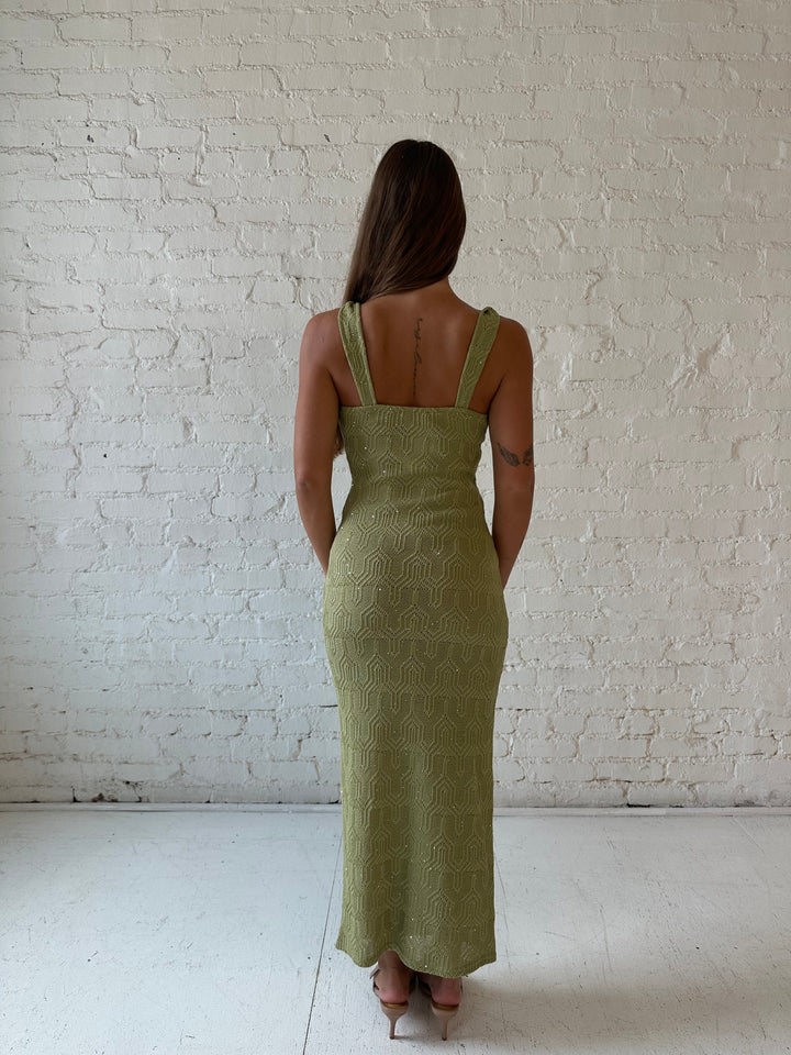 Woman wearing olive green shimmer knit midi dress.