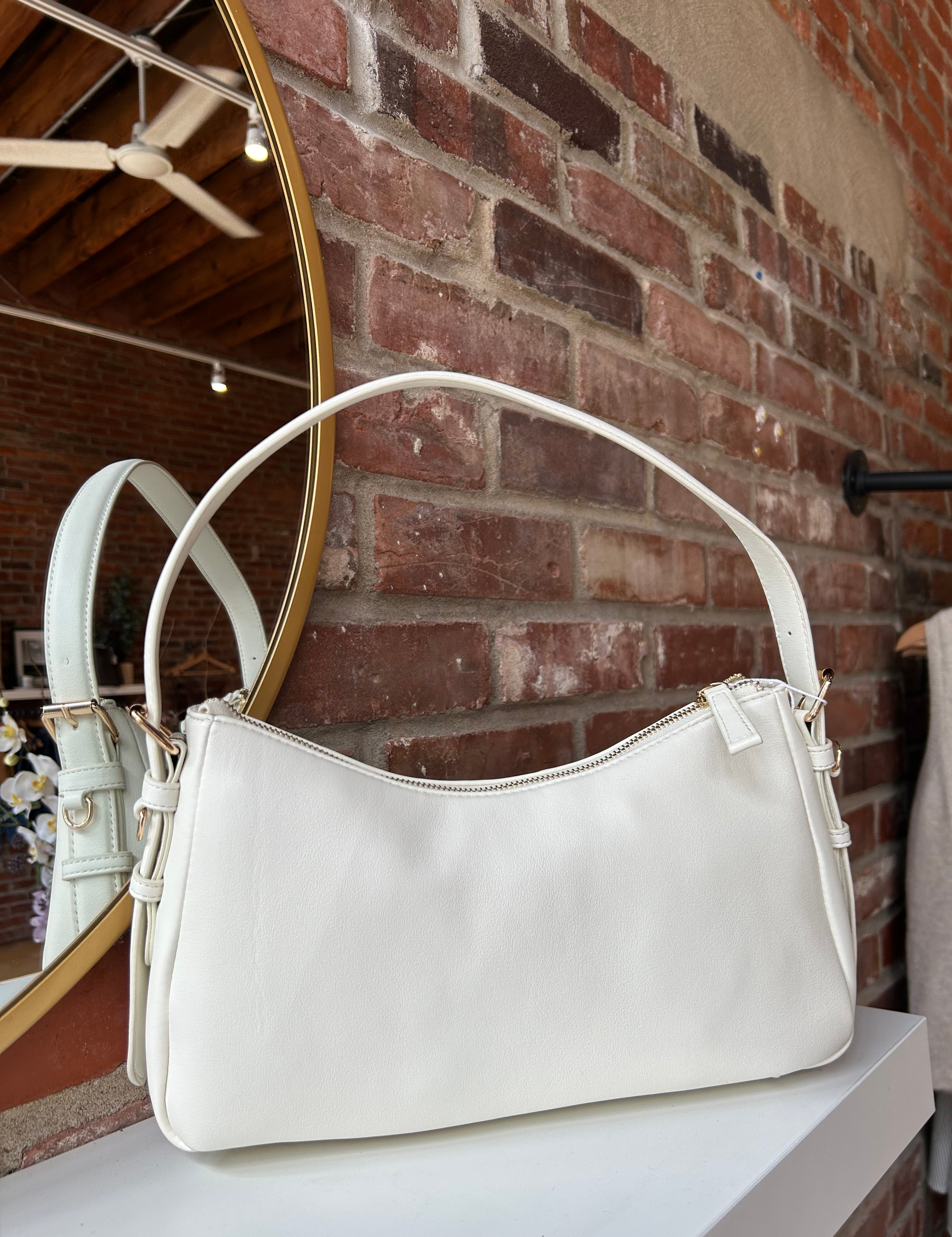 Bone leather shoulder bag with zip closure, sleek silhouette, and adjustable strap