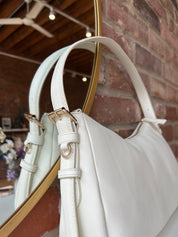 Bone leather shoulder bag with zip closure, sleek silhouette, and adjustable strap