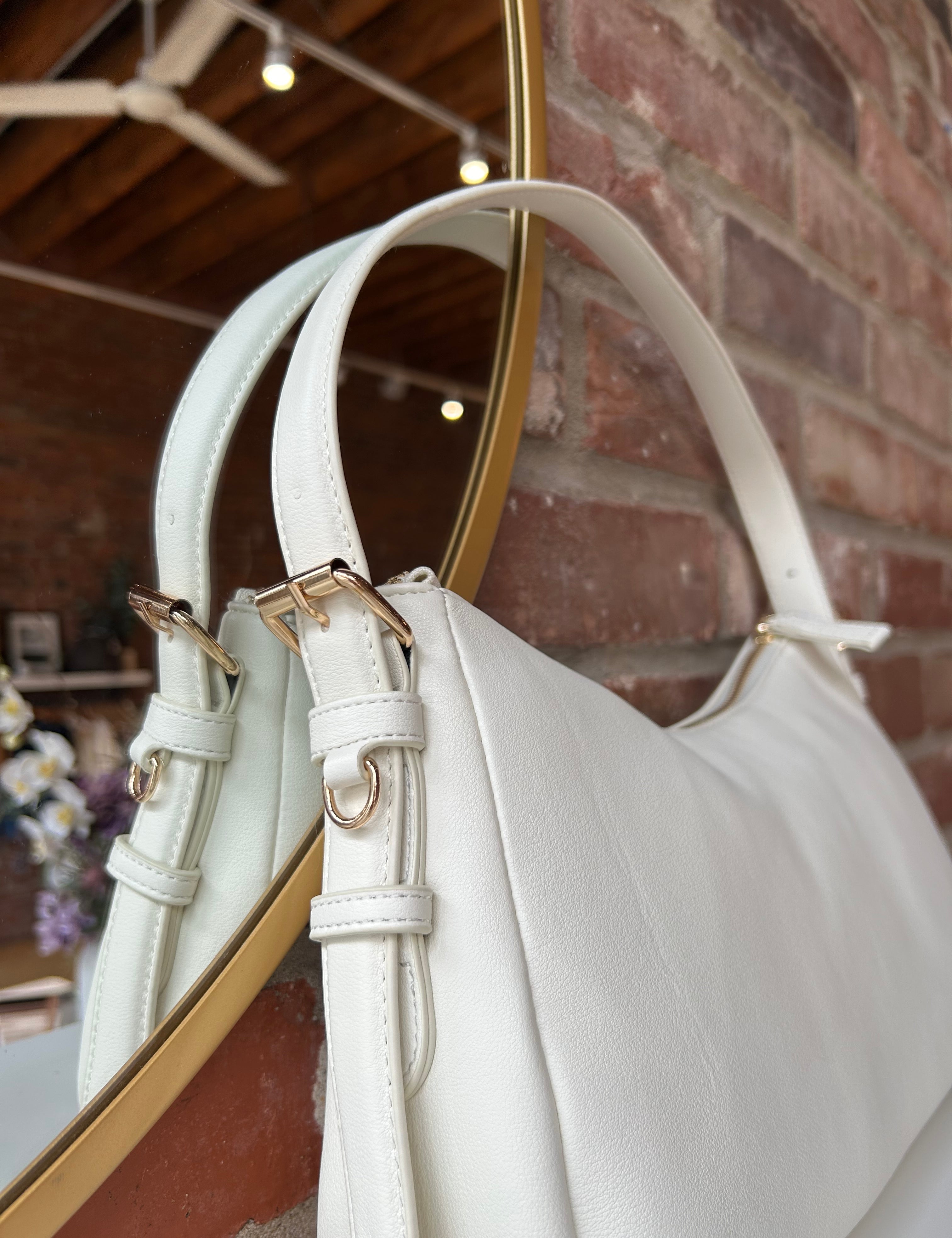 Bone leather shoulder bag with zip closure, sleek silhouette, and adjustable strap