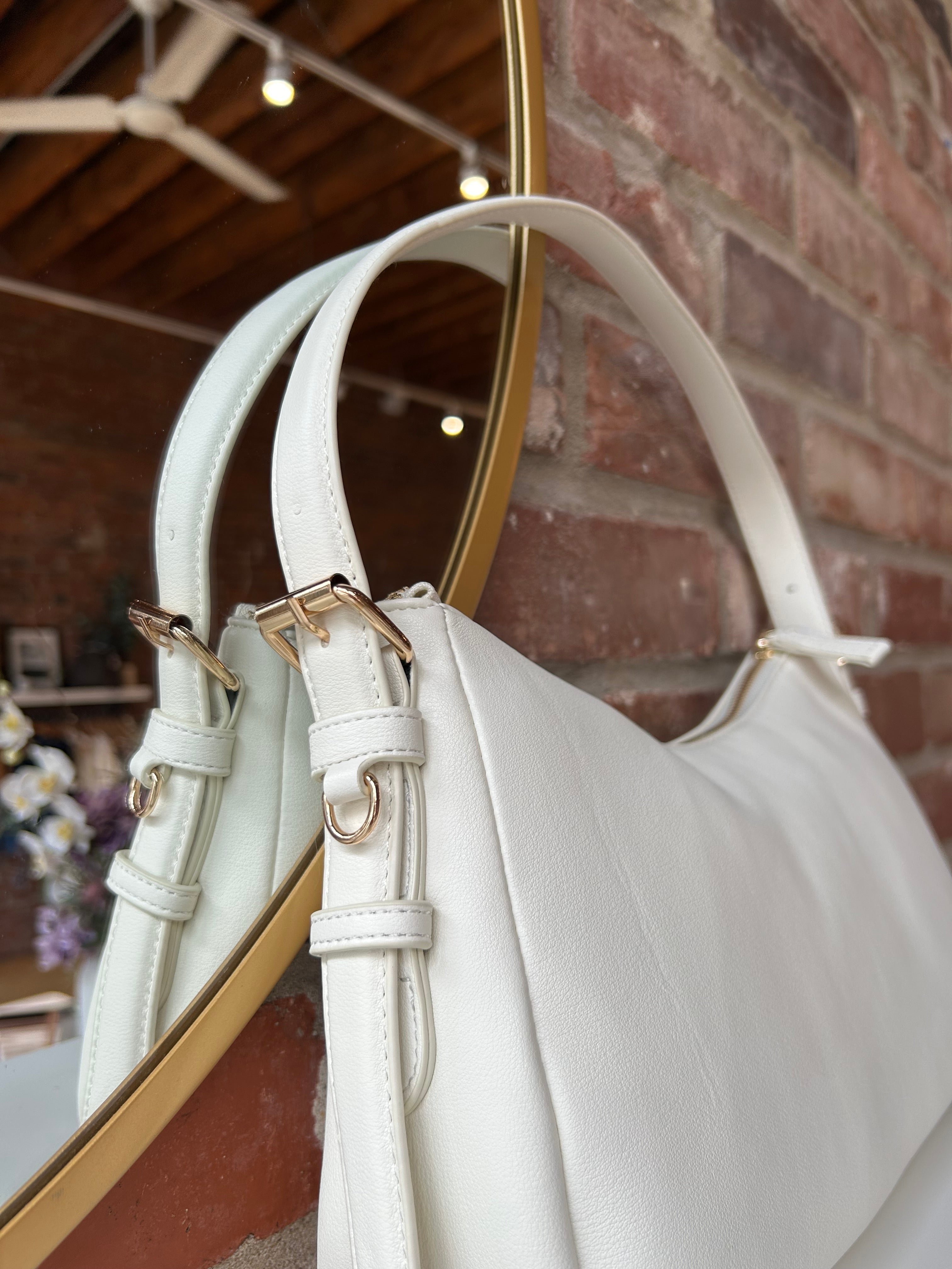 Bone leather shoulder bag with zip closure, sleek silhouette, and adjustable strap