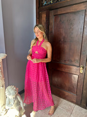Hot pink checkered halter maxi dress with a cutout and flowy skirt