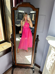 Hot pink checkered halter maxi dress with a cutout and flowy skirt