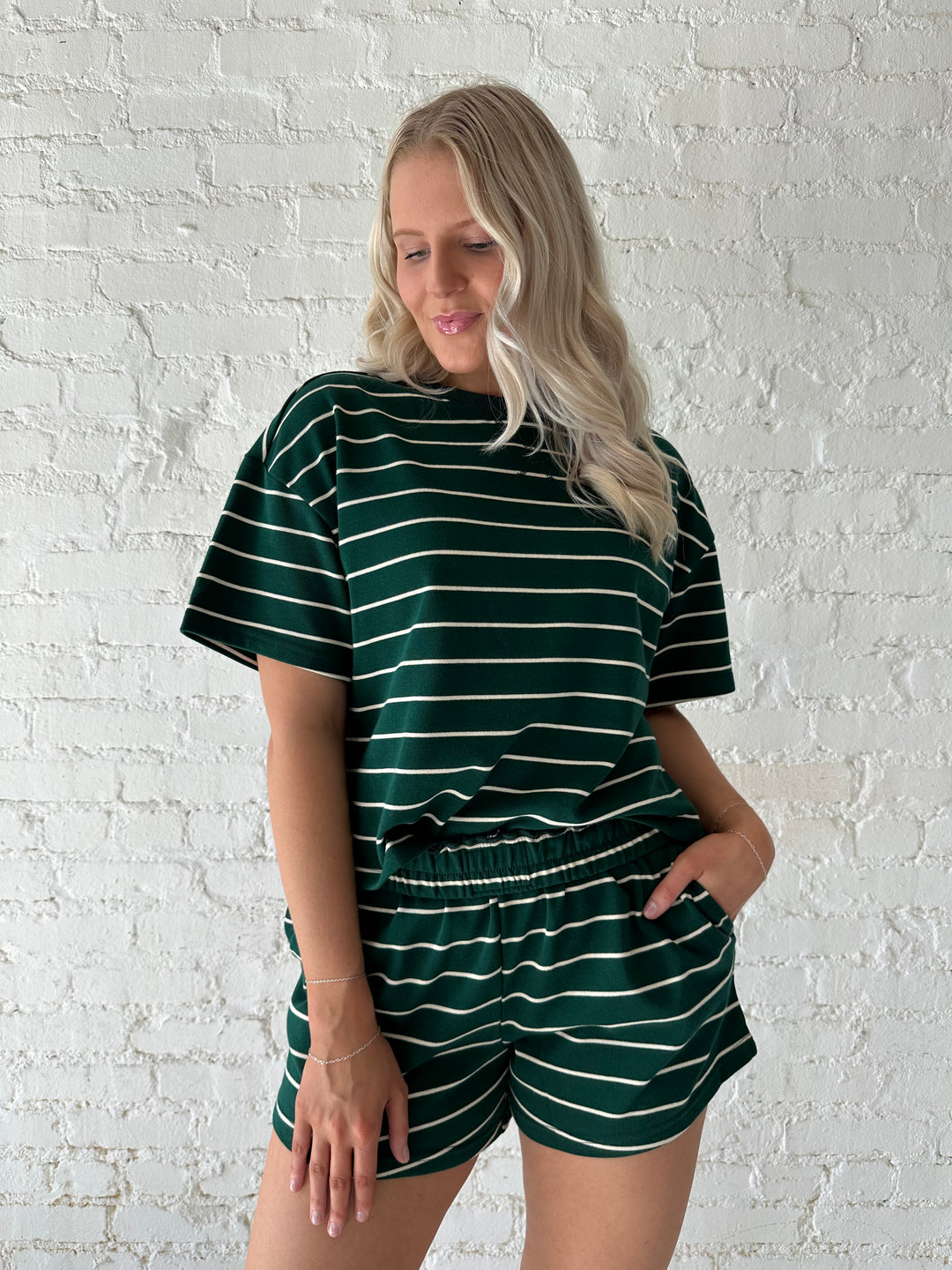 Woman wearing green and white striped two piece lounge set.