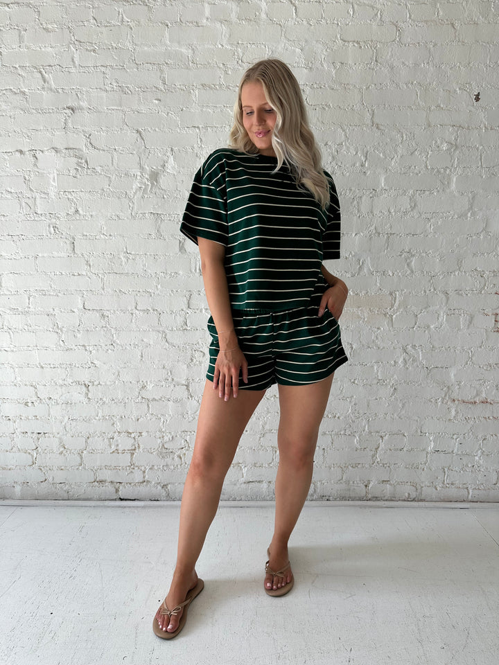 Woman wearing green and white striped two piece lounge set.