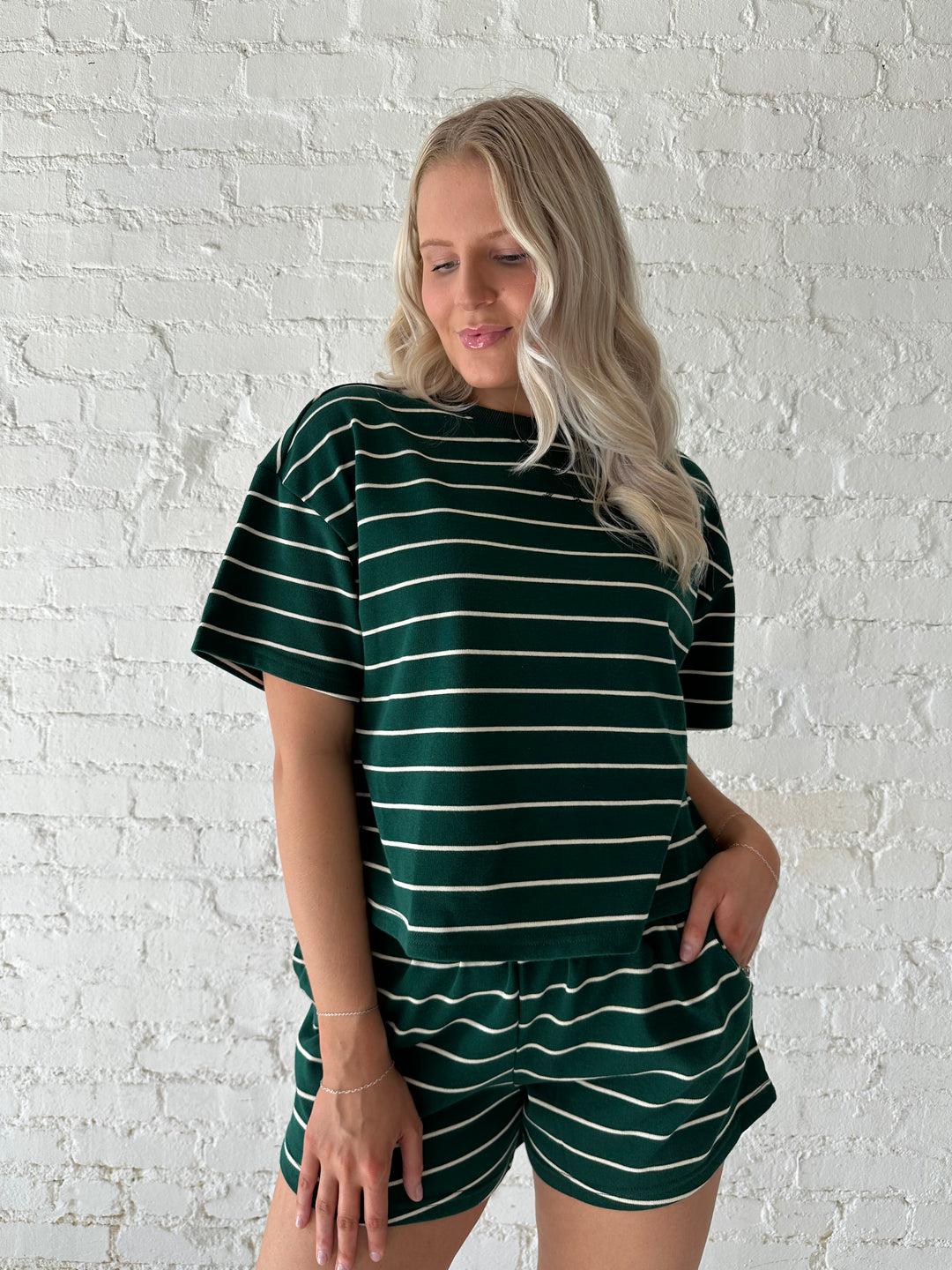 Woman wearing green and white striped two piece lounge set.