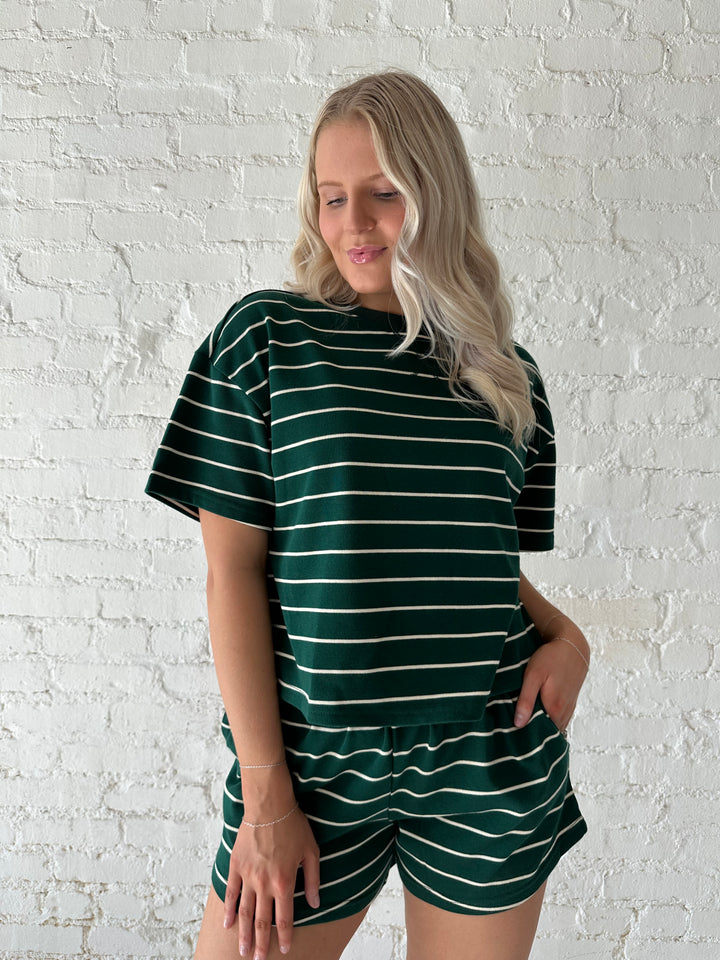 Woman wearing green and white striped two piece lounge set.
