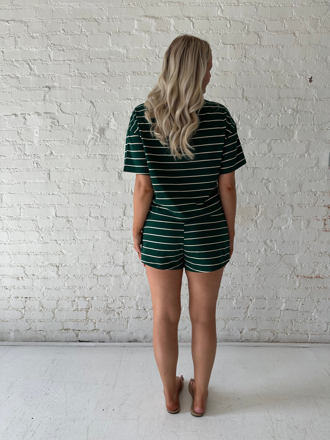 Woman wearing green and white striped two piece lounge set.