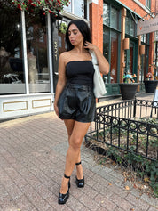 Black tube top with ruched sides.