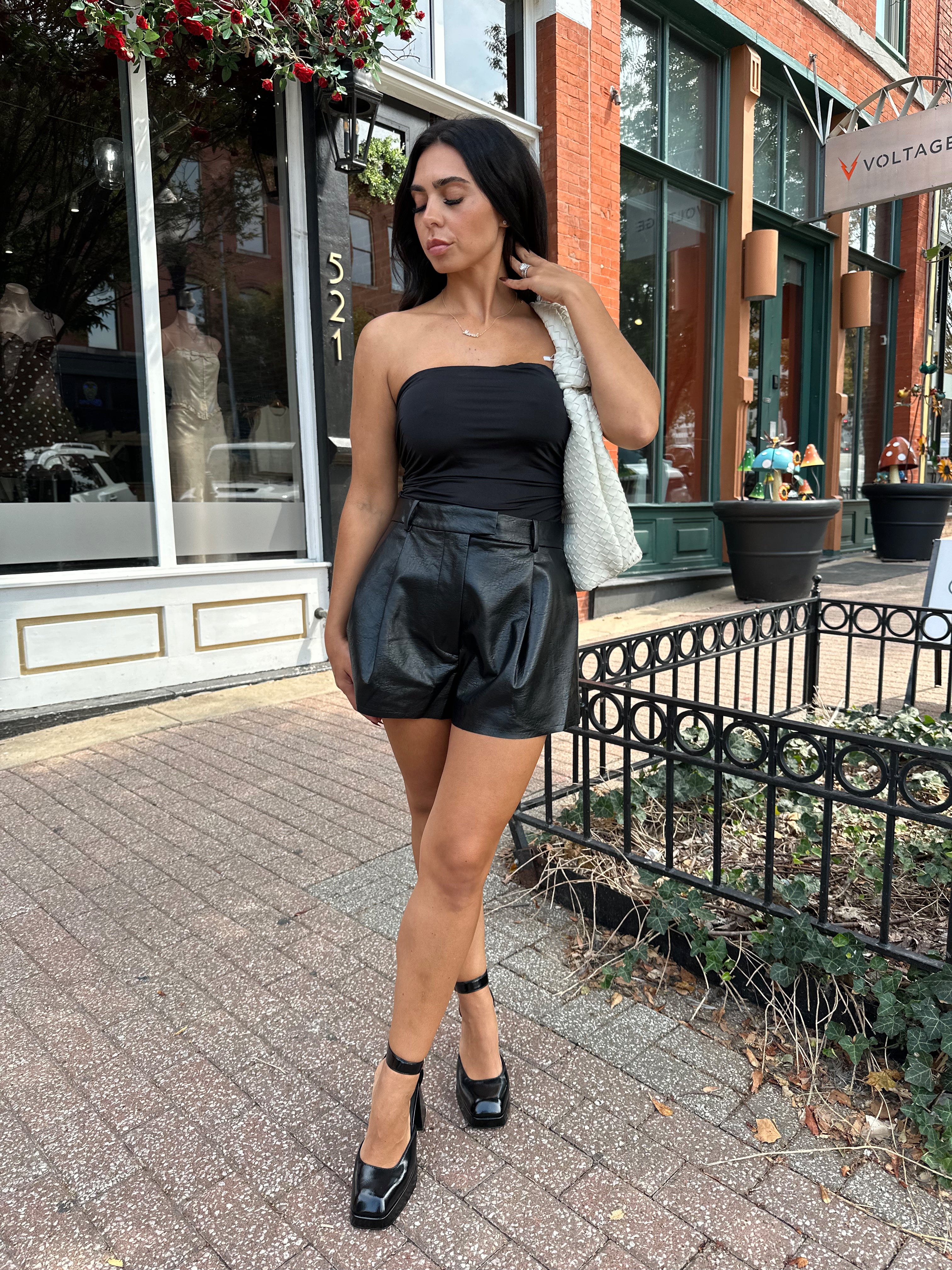 Black tube top with ruched sides.