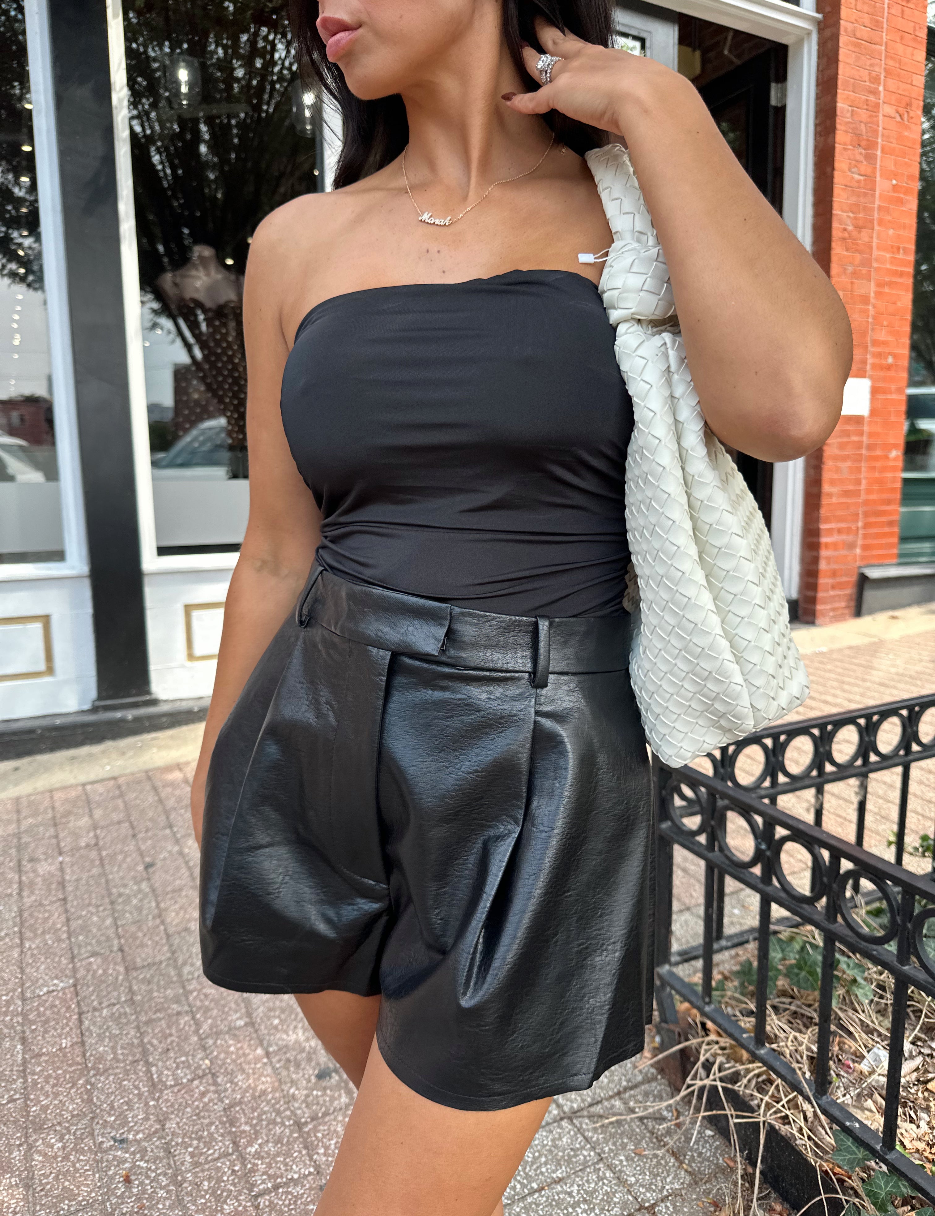 Black tube top with ruched sides.