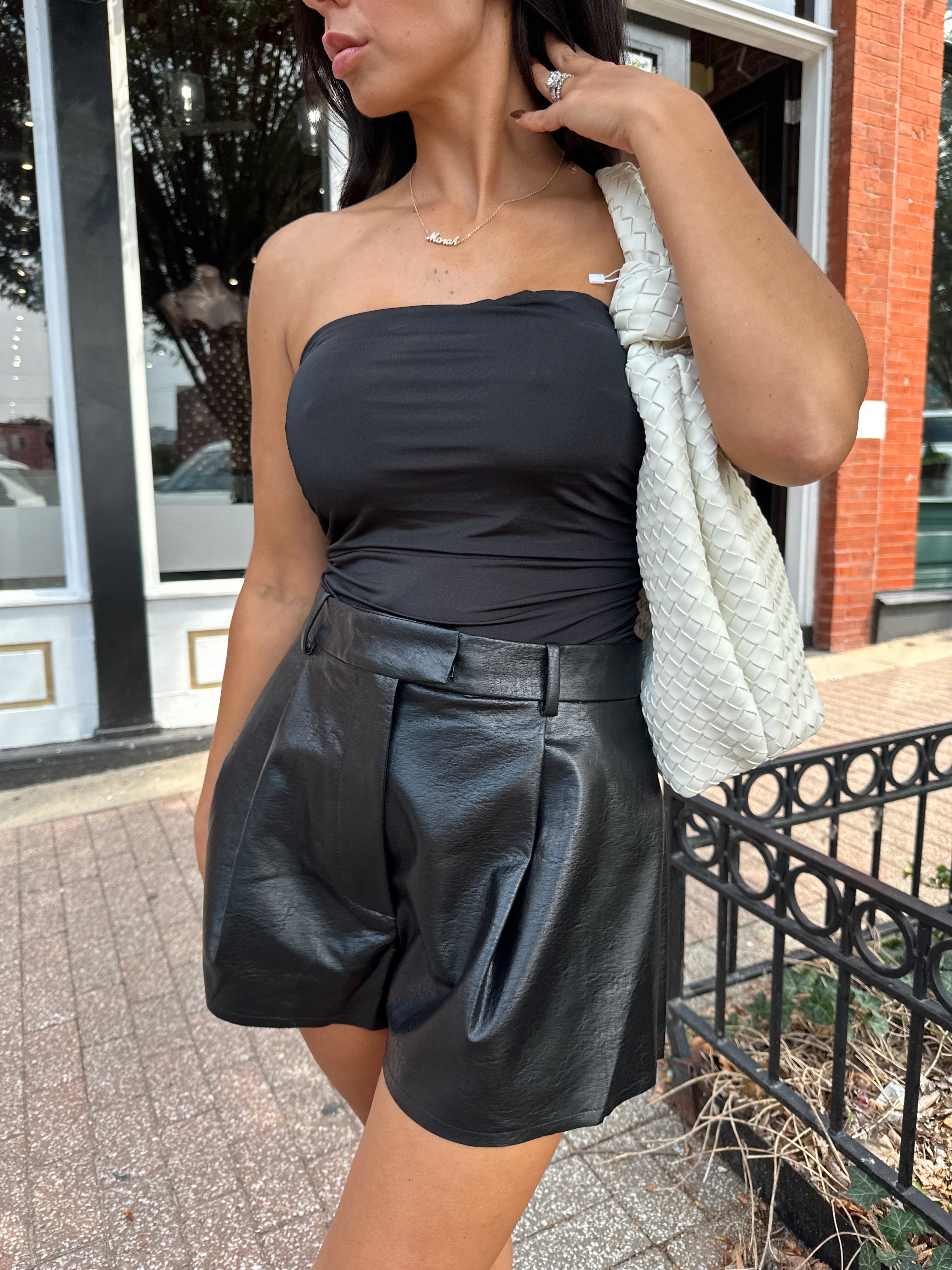 Black tube top with ruched sides.