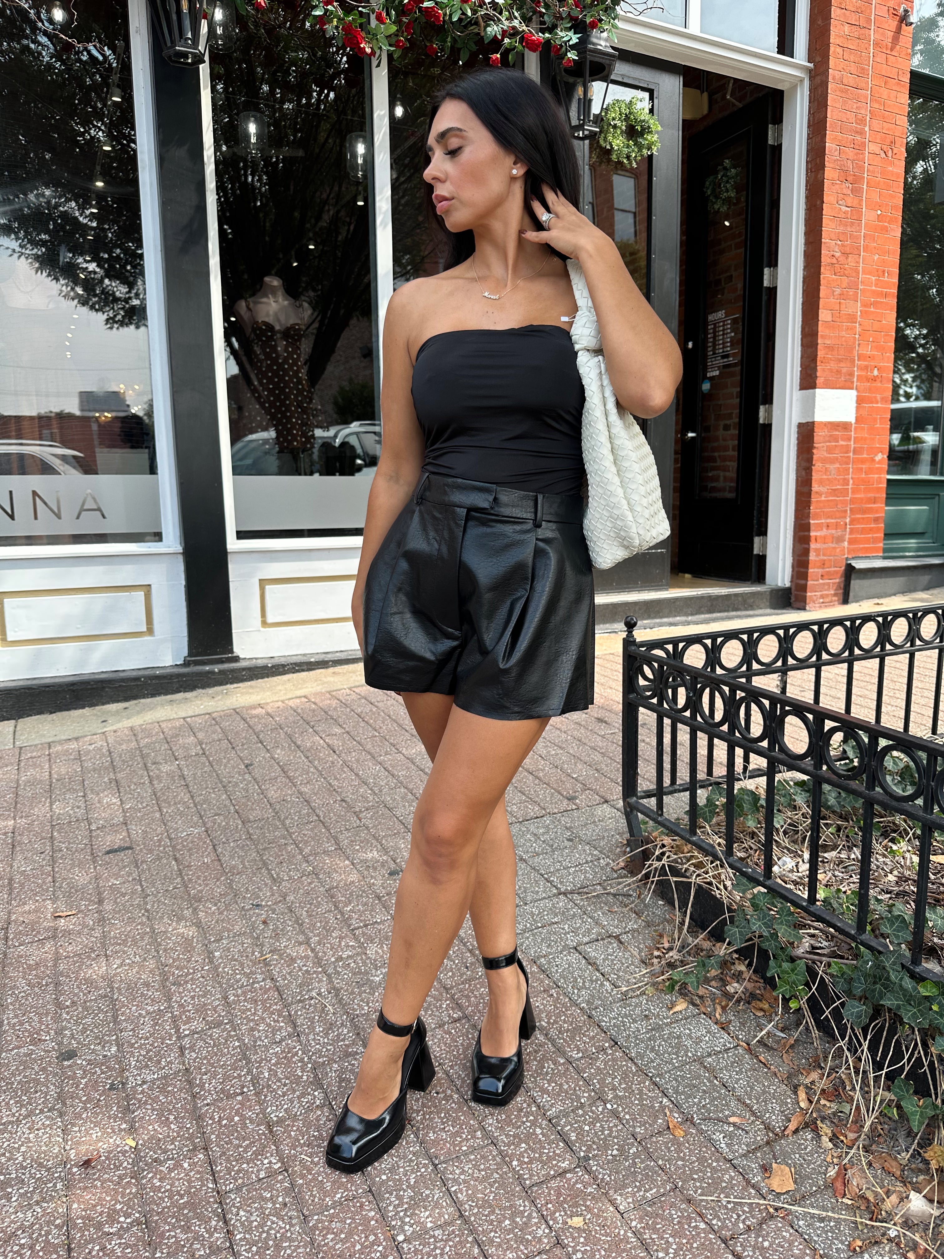 Black tube top with ruched sides.