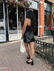 Black tube top with ruched sides.
