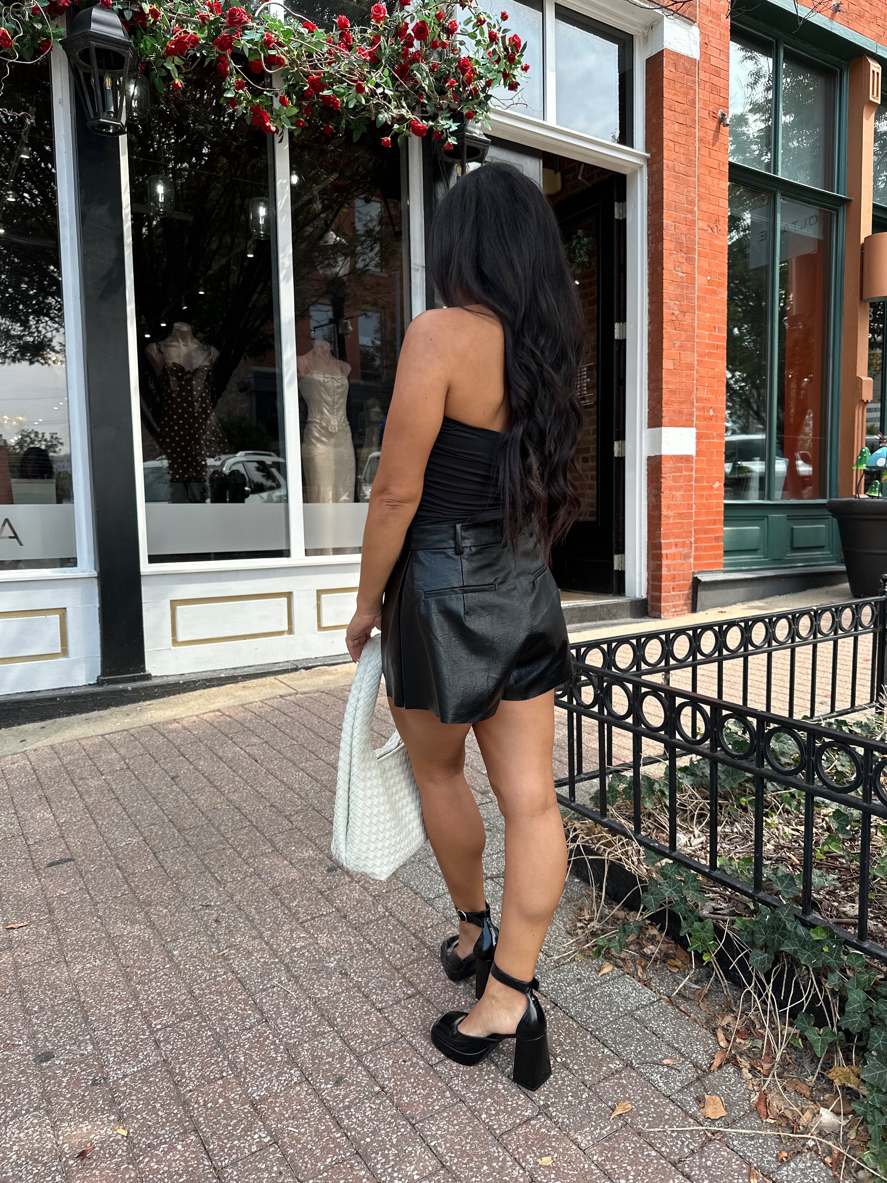 Black tube top with ruched sides.