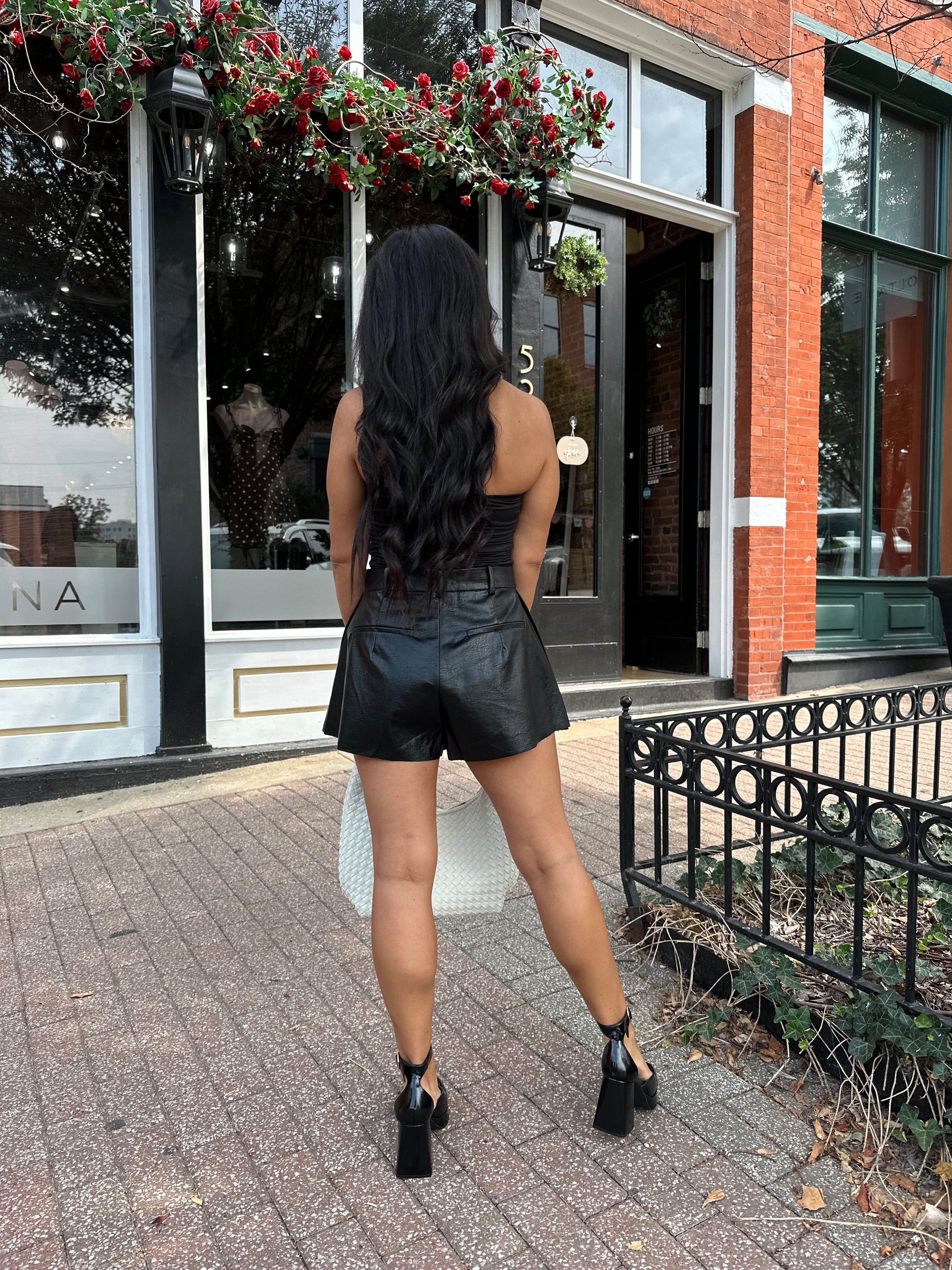 Black tube top with ruched sides.