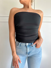 Black tube top with ruched sides.