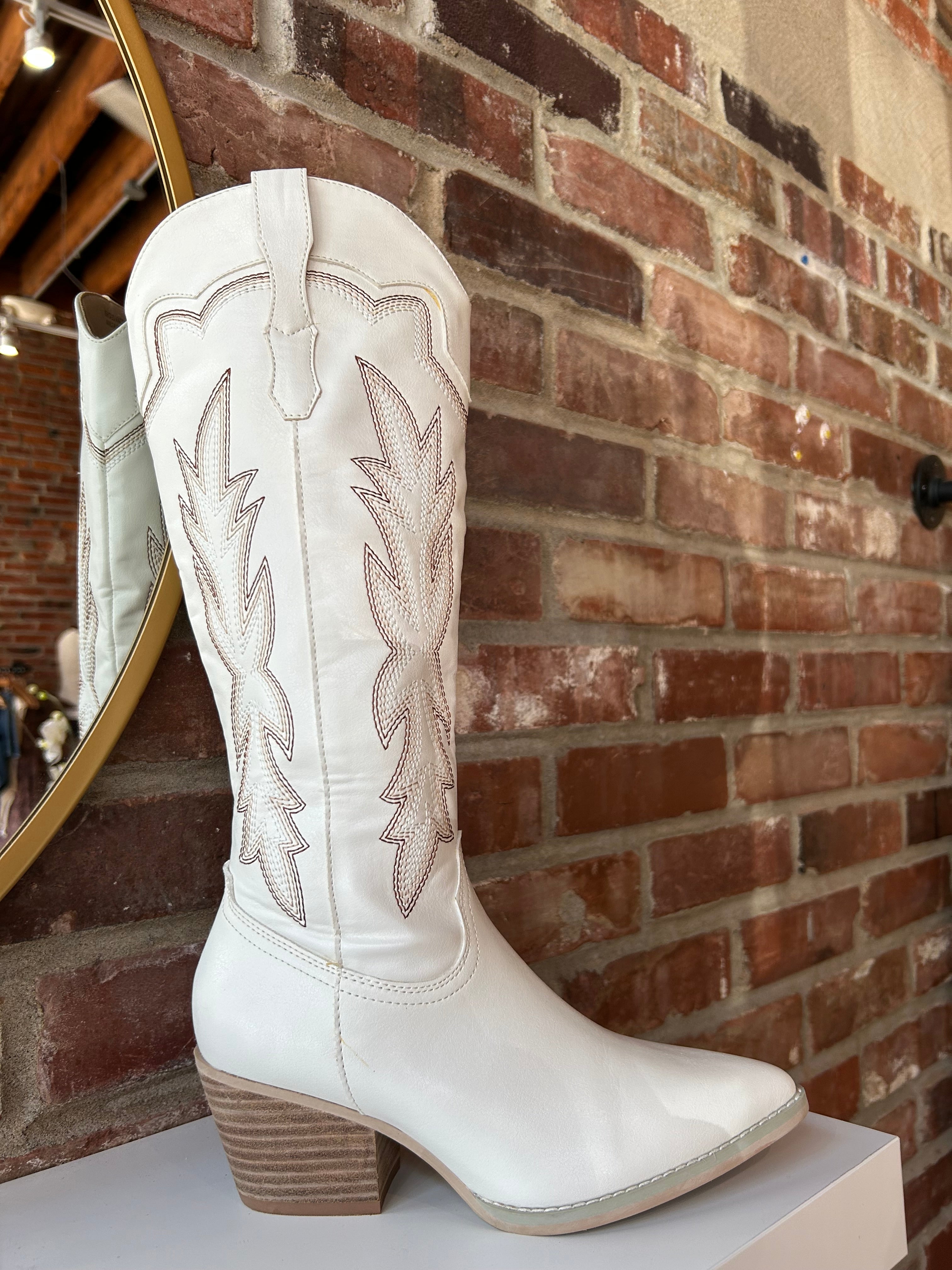 White Western boot with brown stitching, pointed toe, and stacked block heel