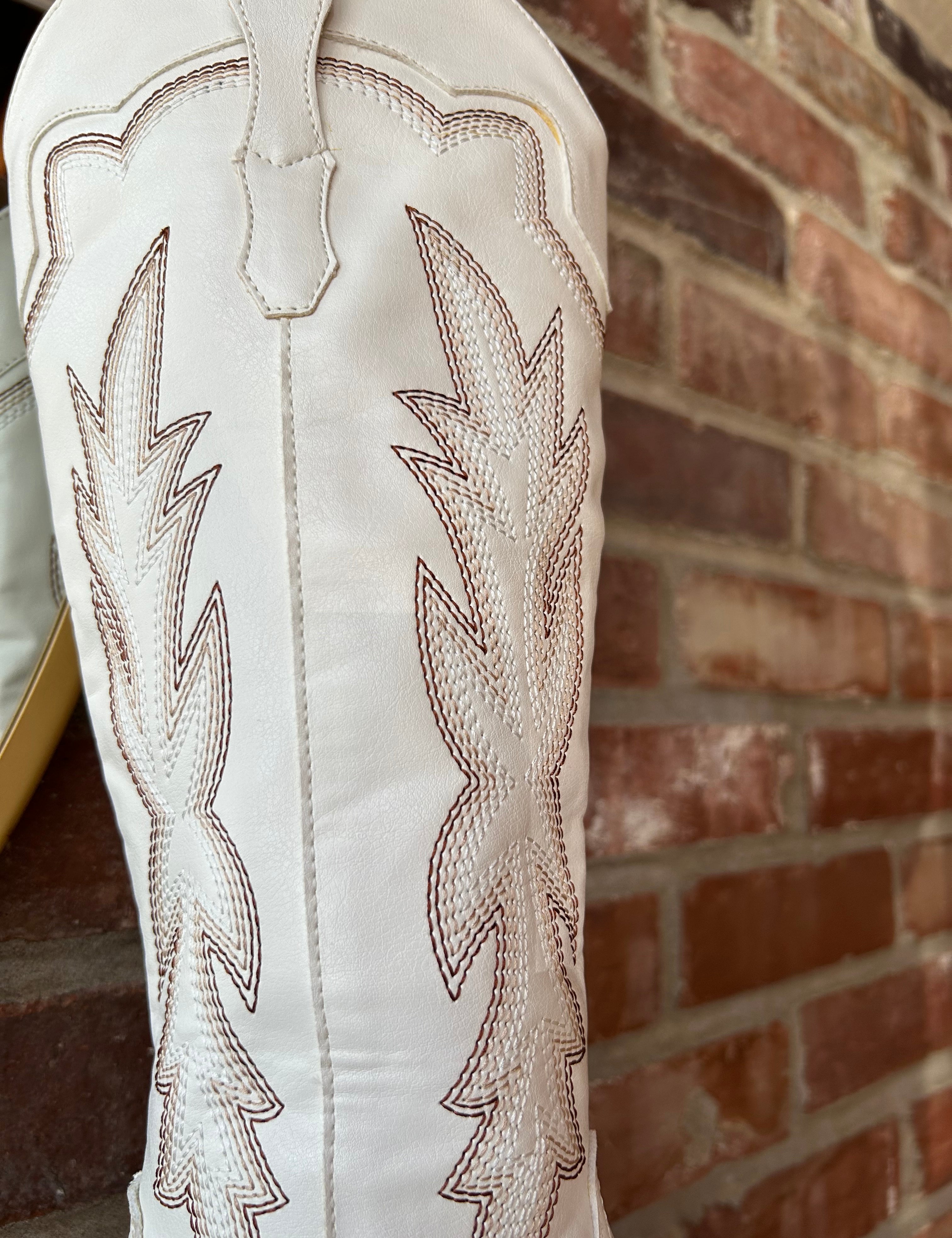 White Western boot with brown stitching, pointed toe, and stacked block heel