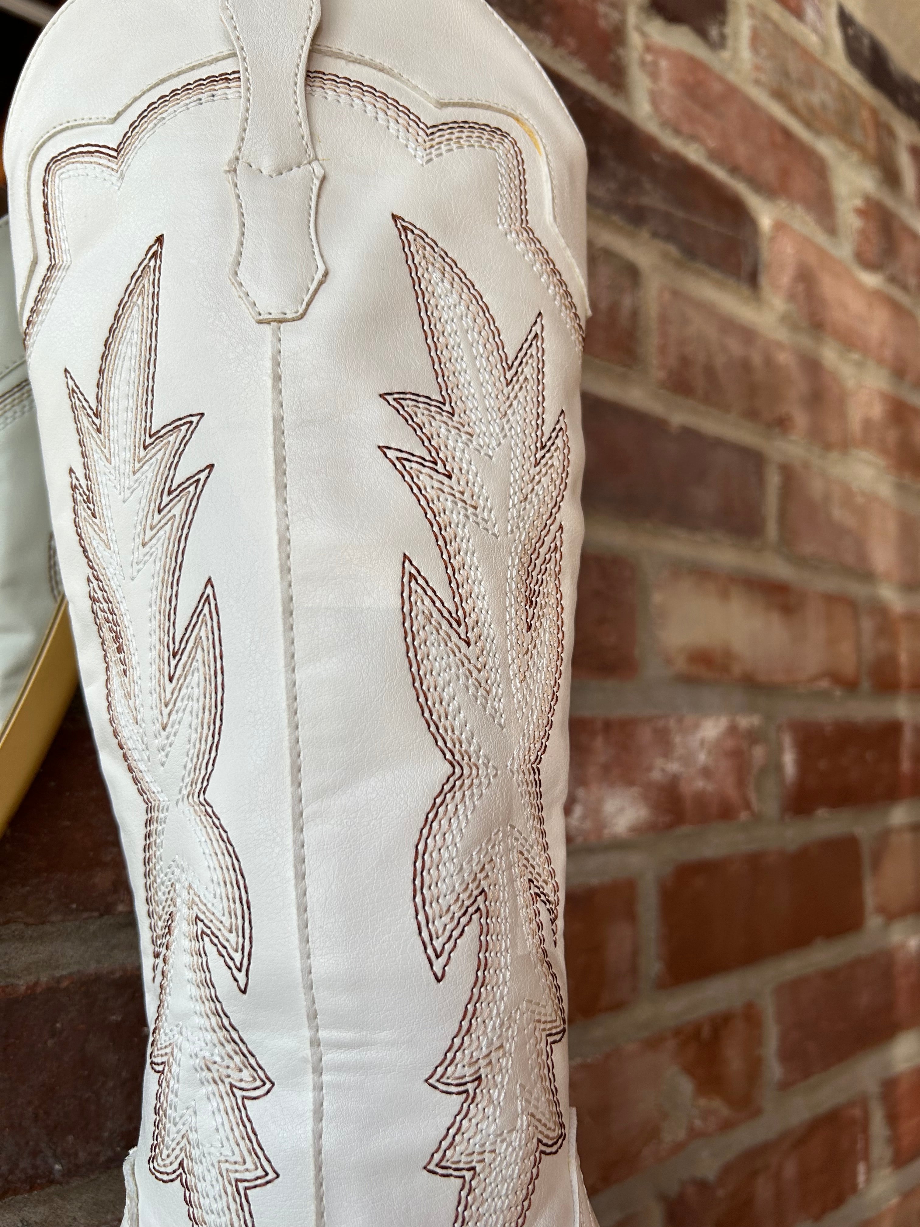 White Western boot with brown stitching, pointed toe, and stacked block heel