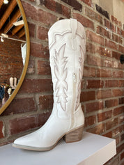 White Western boot with brown stitching, pointed toe, and stacked block heel
