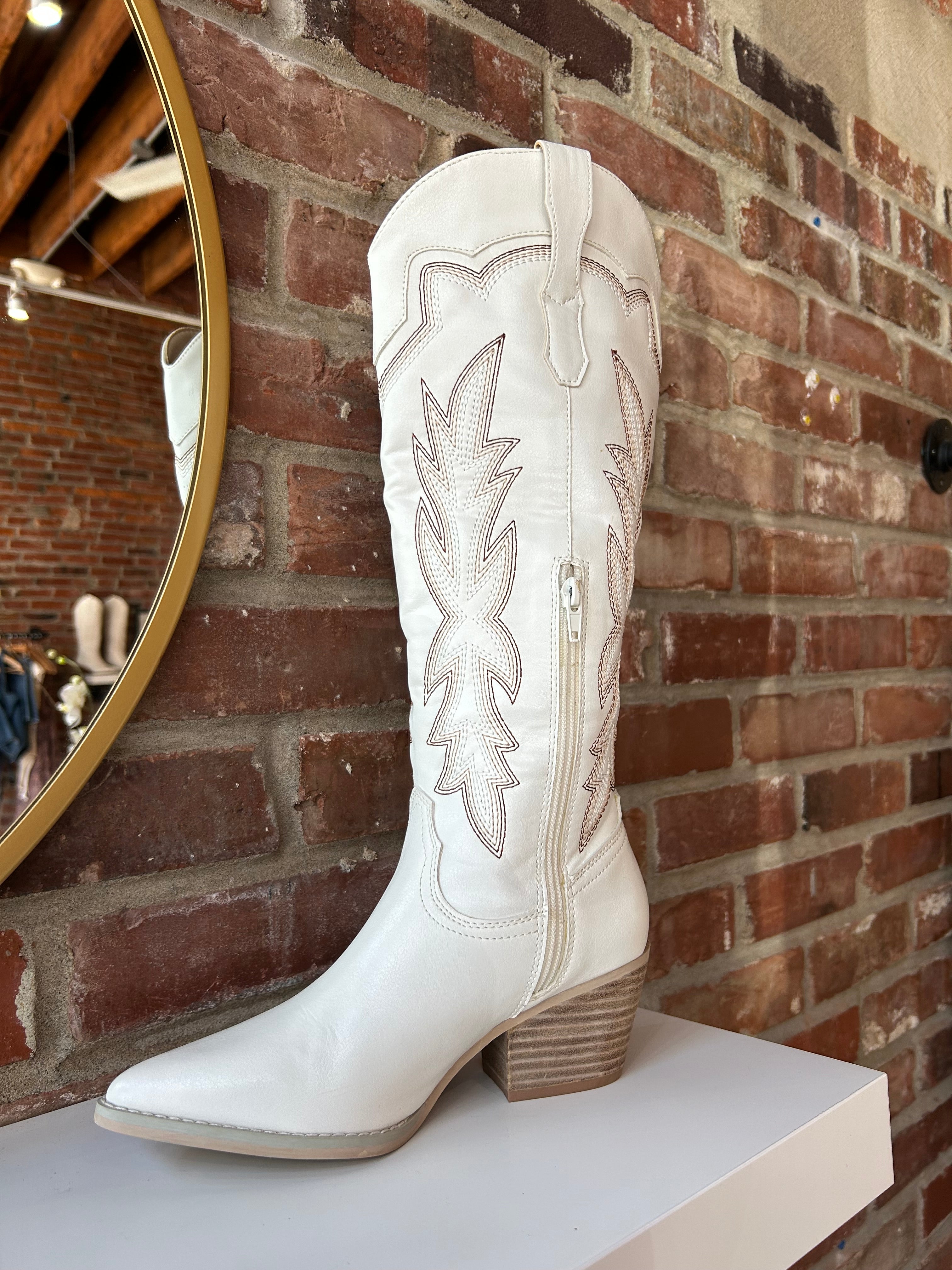 White Western boot with brown stitching, pointed toe, and stacked block heel