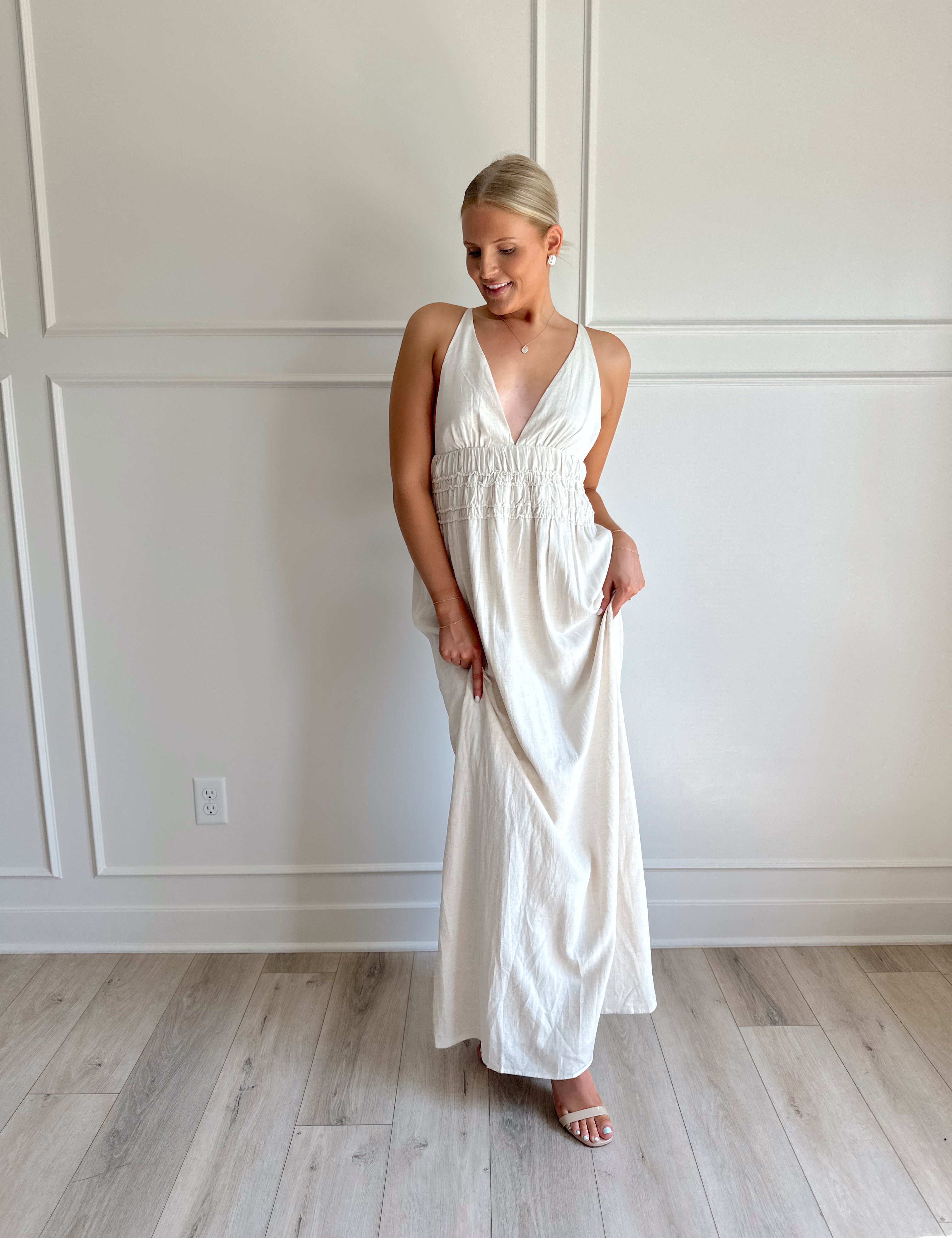 Oatmeal colored maxi dress with ruched midsection and criss cross back.
