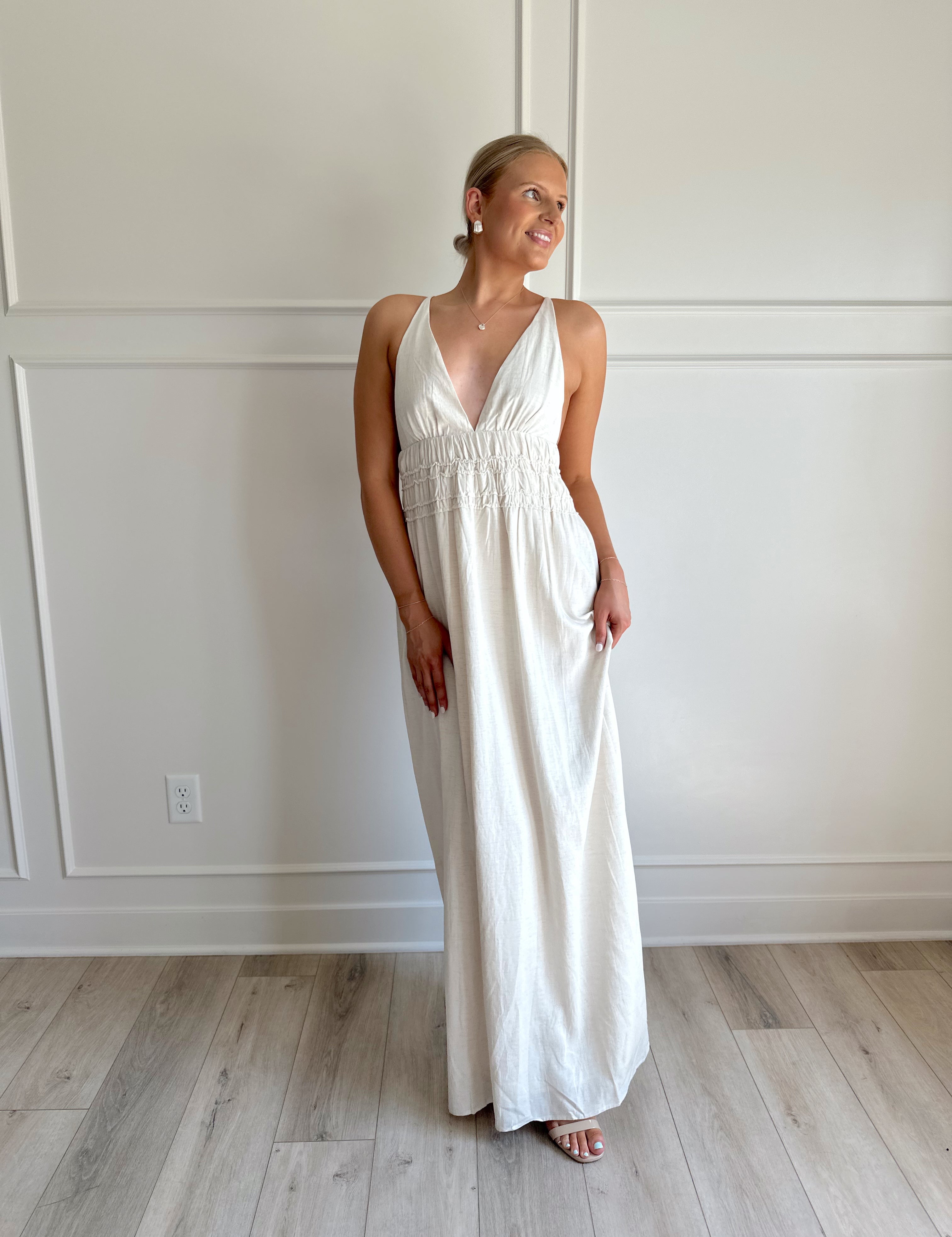 Oatmeal colored maxi dress with ruched midsection and criss cross back.