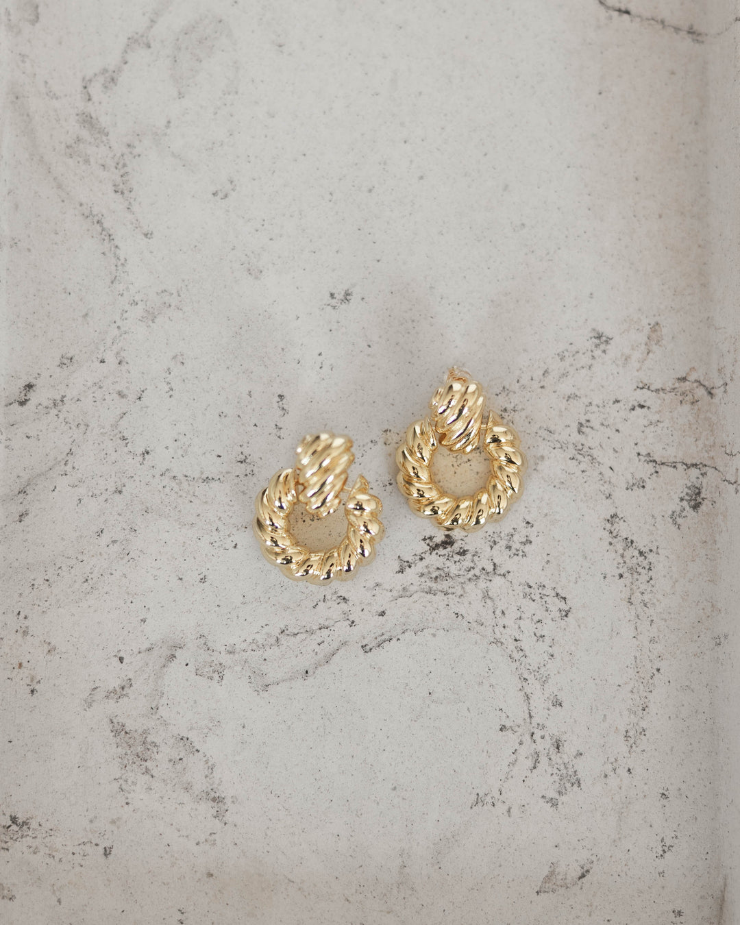 Twisted gold plated hoop earring. 
