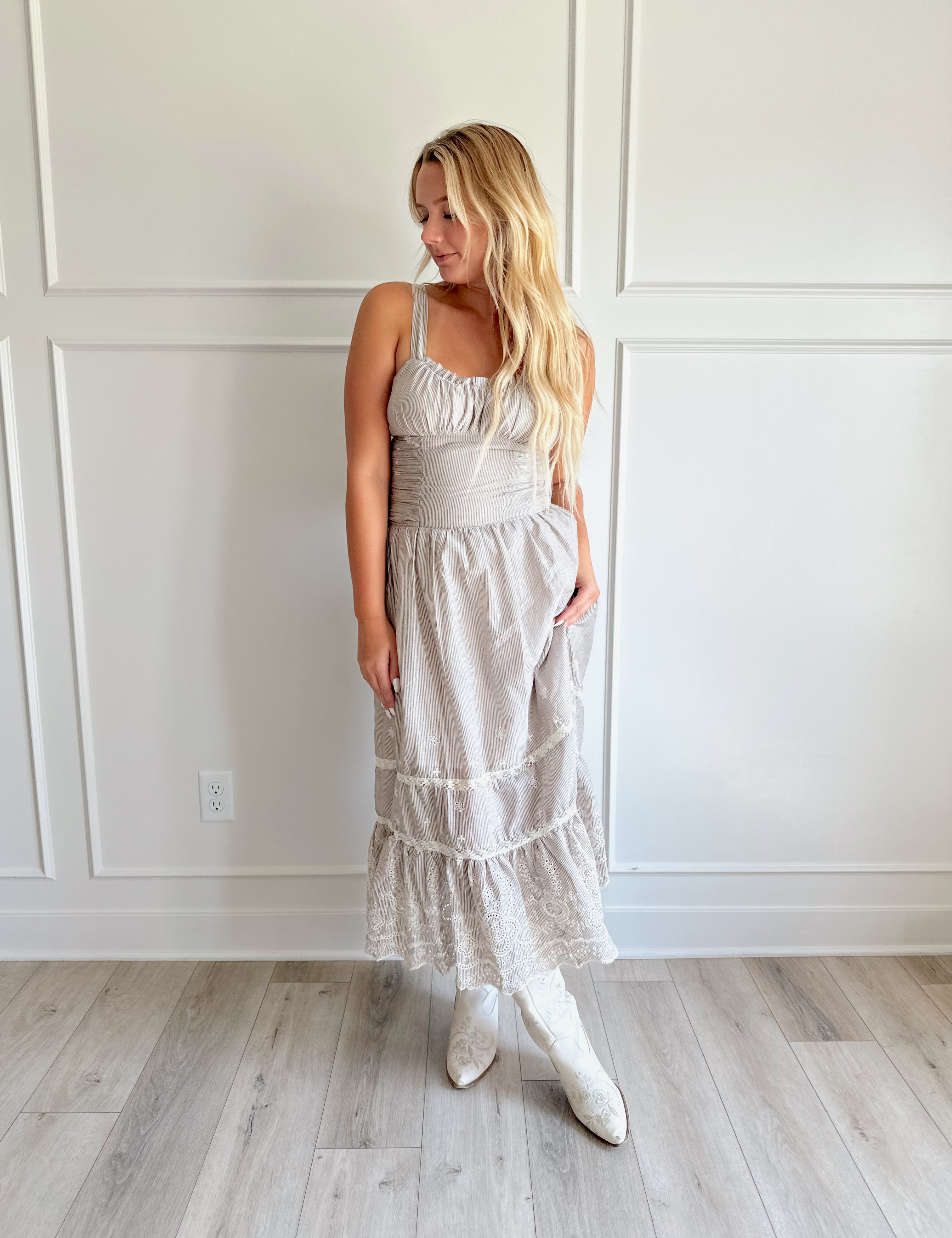 Beige striped midi dress with eyelet detailing and tiered skirt.