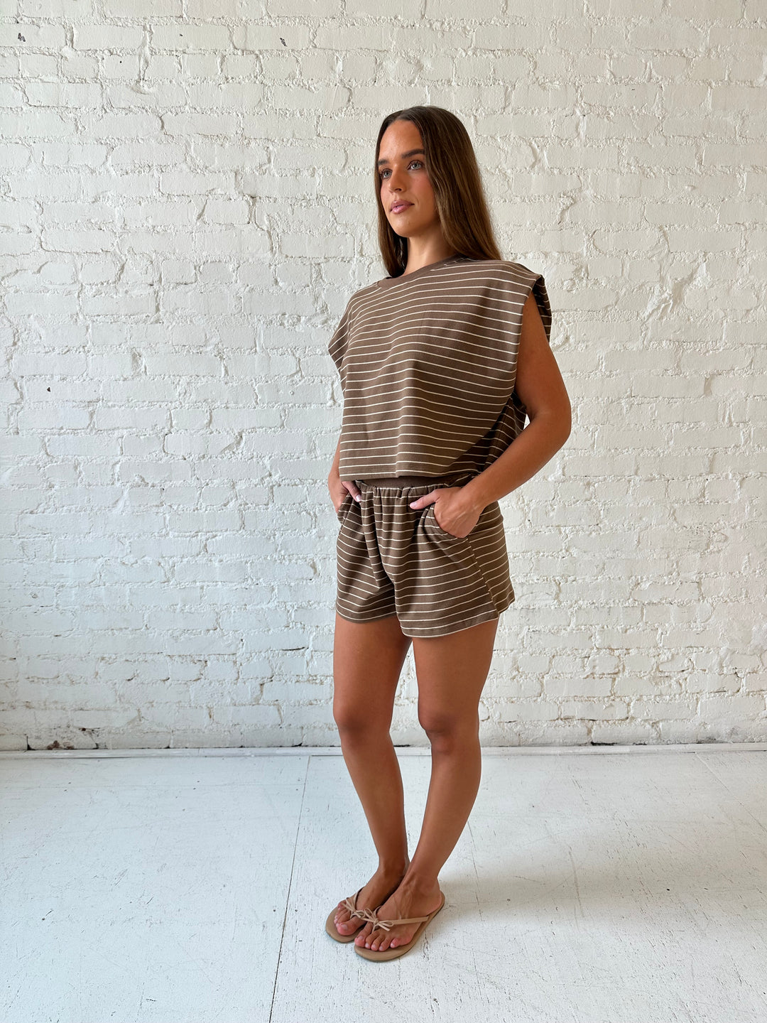 Woman wearing brown and tan striped two piece short lounge set. 